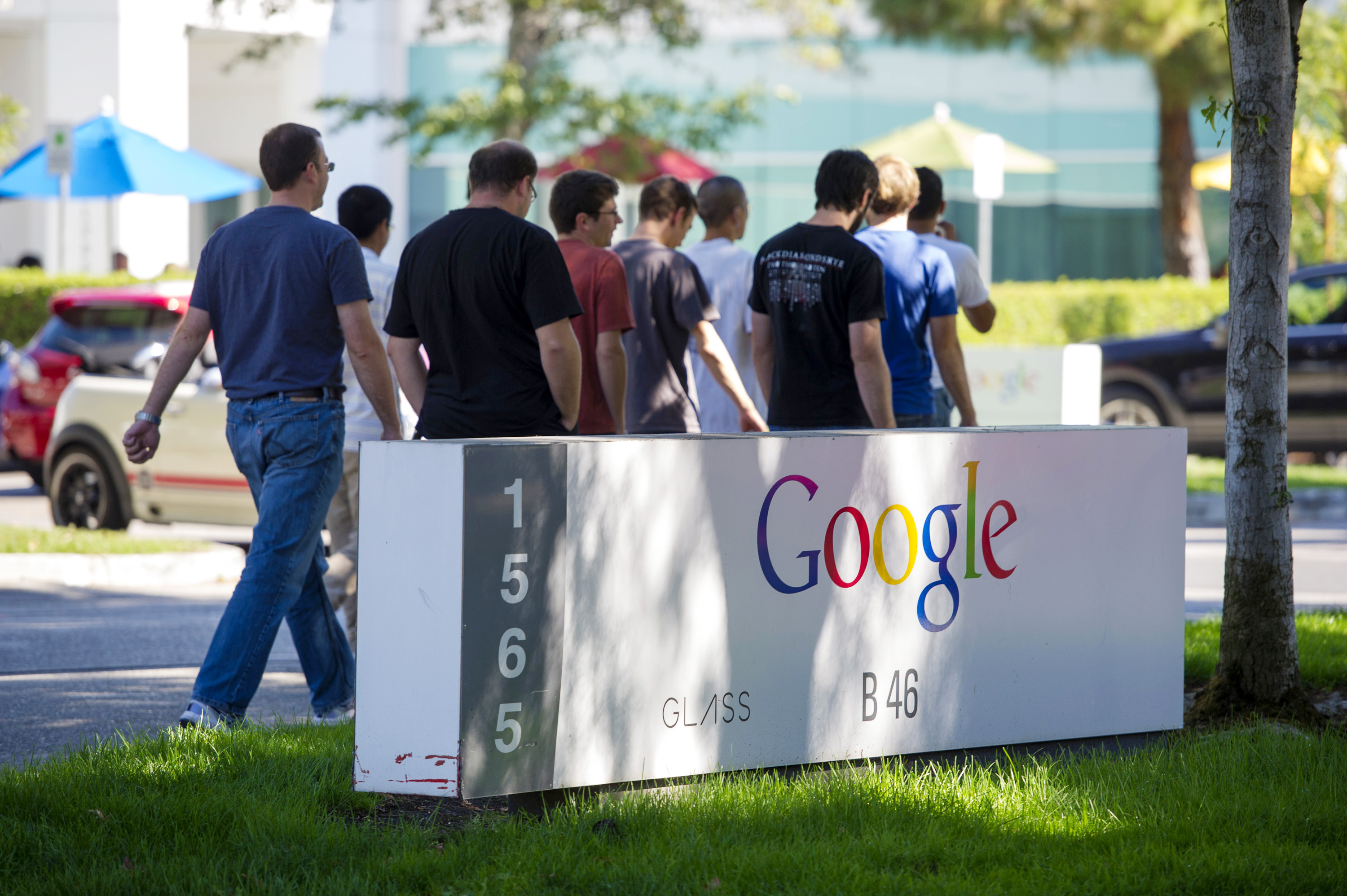 Pedestrians walk past Google Inc. signage displayed in front of the company's headquarters in Mountain View, Calif. on Sept. 27, 2013. (David Paul Morris—Bloomberg/Getty Images)