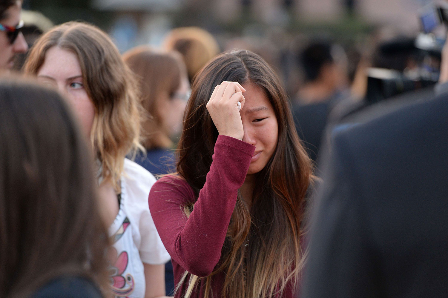 A student weeps during a candlelight vigil on May 24, 2014, for those affected by a killing spree in Isla Vista, on the University of California, Santa Barbara, campus (Robyn Beck—AFP/Getty Images)
