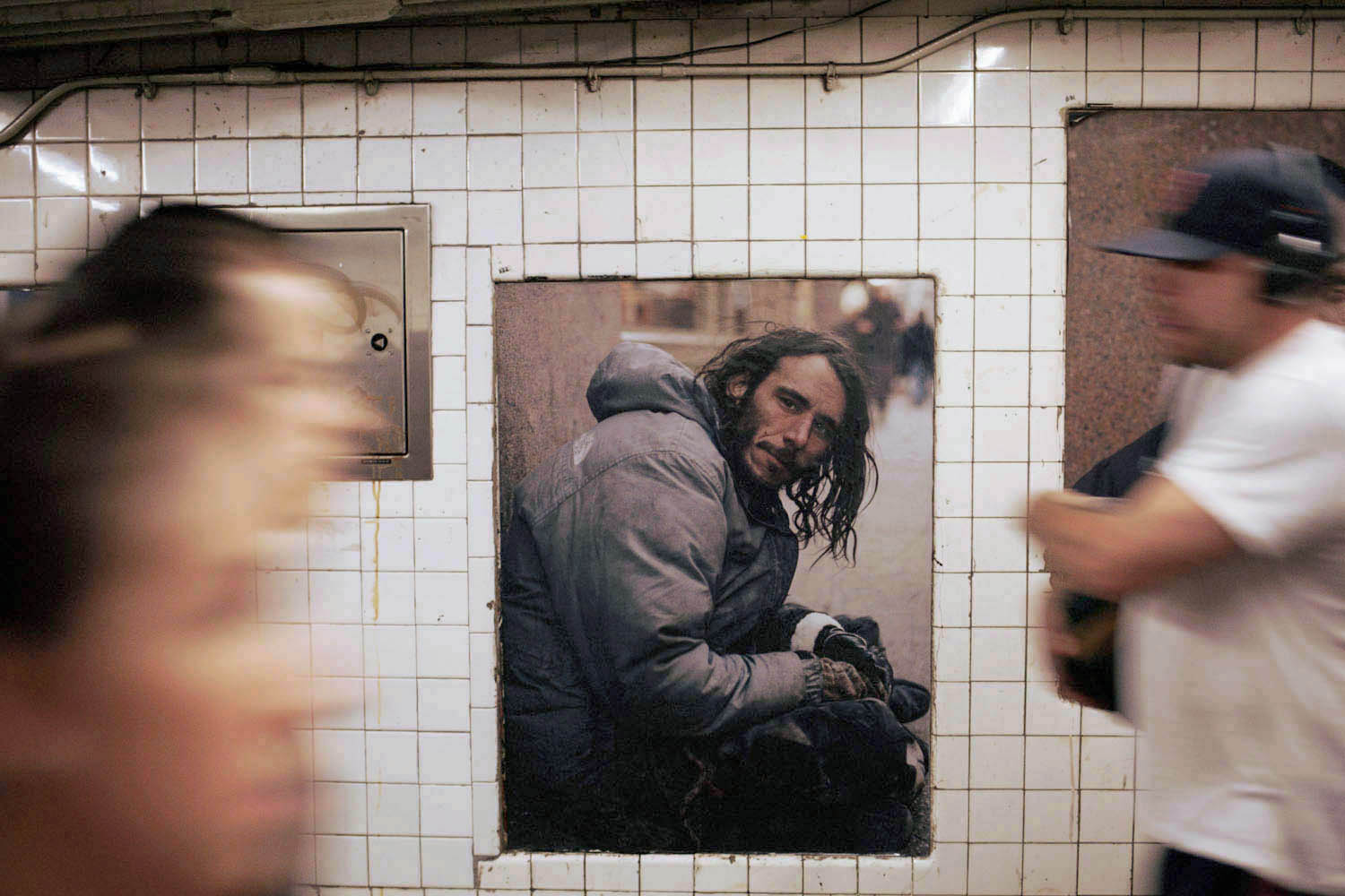 Artist Andres Serrano's photographic installation, Residents of New York, at the West 4th Street subway  station in New York City.