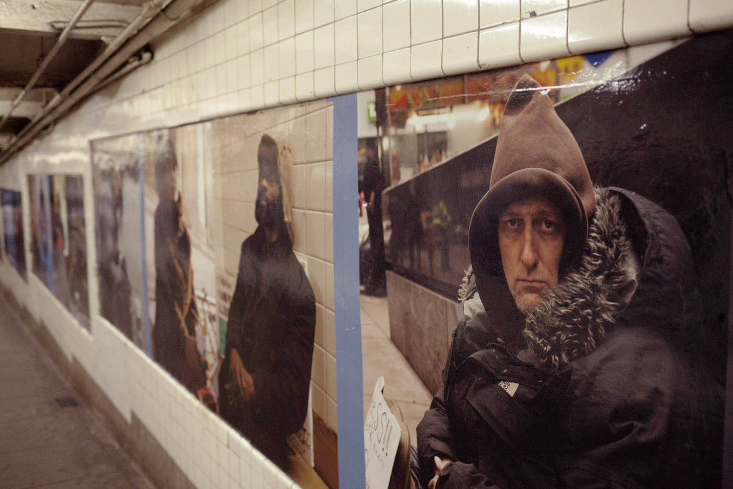 Artist, Andres Serrano's photographic installation, Residents of New York, at the West 4th Street subway  station in New York City.