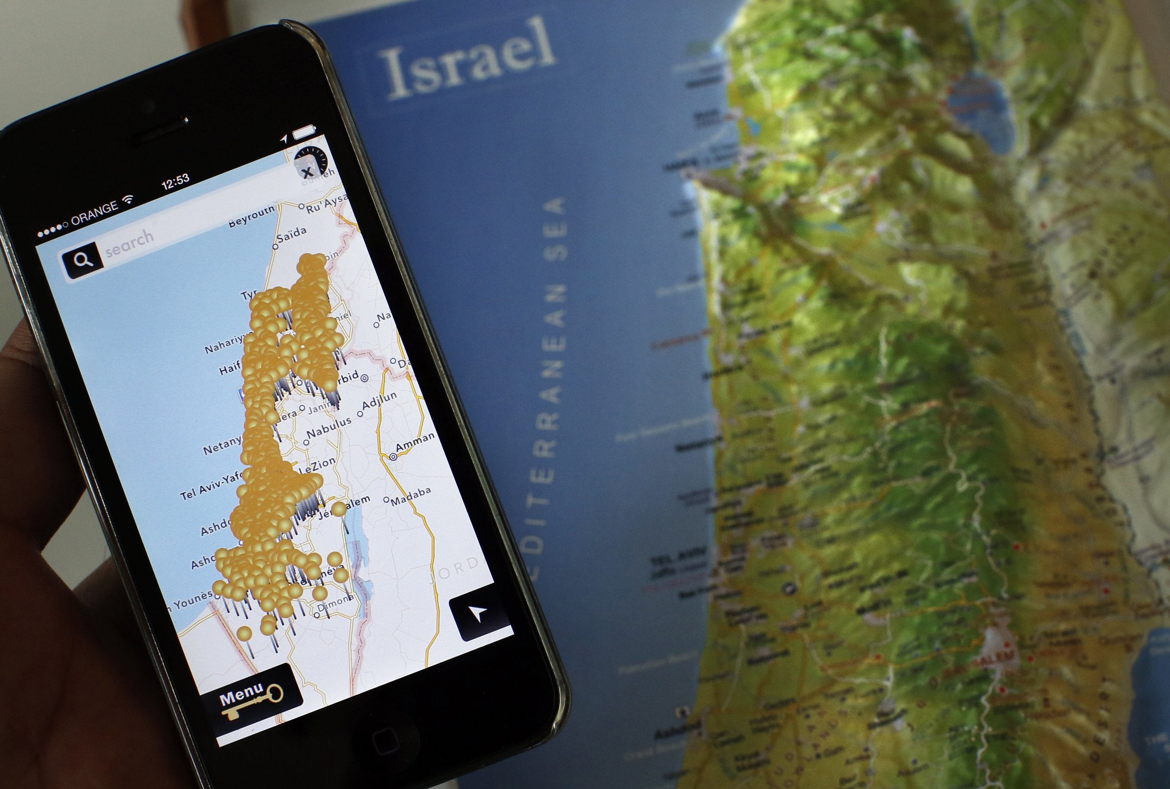 A smartphone placed on an Israeli map in Jerusalem, displaying the new iNakba application that allows users to find the remains of Palestinian villages that now lie inside modern-day Israel, May 5, 2014.