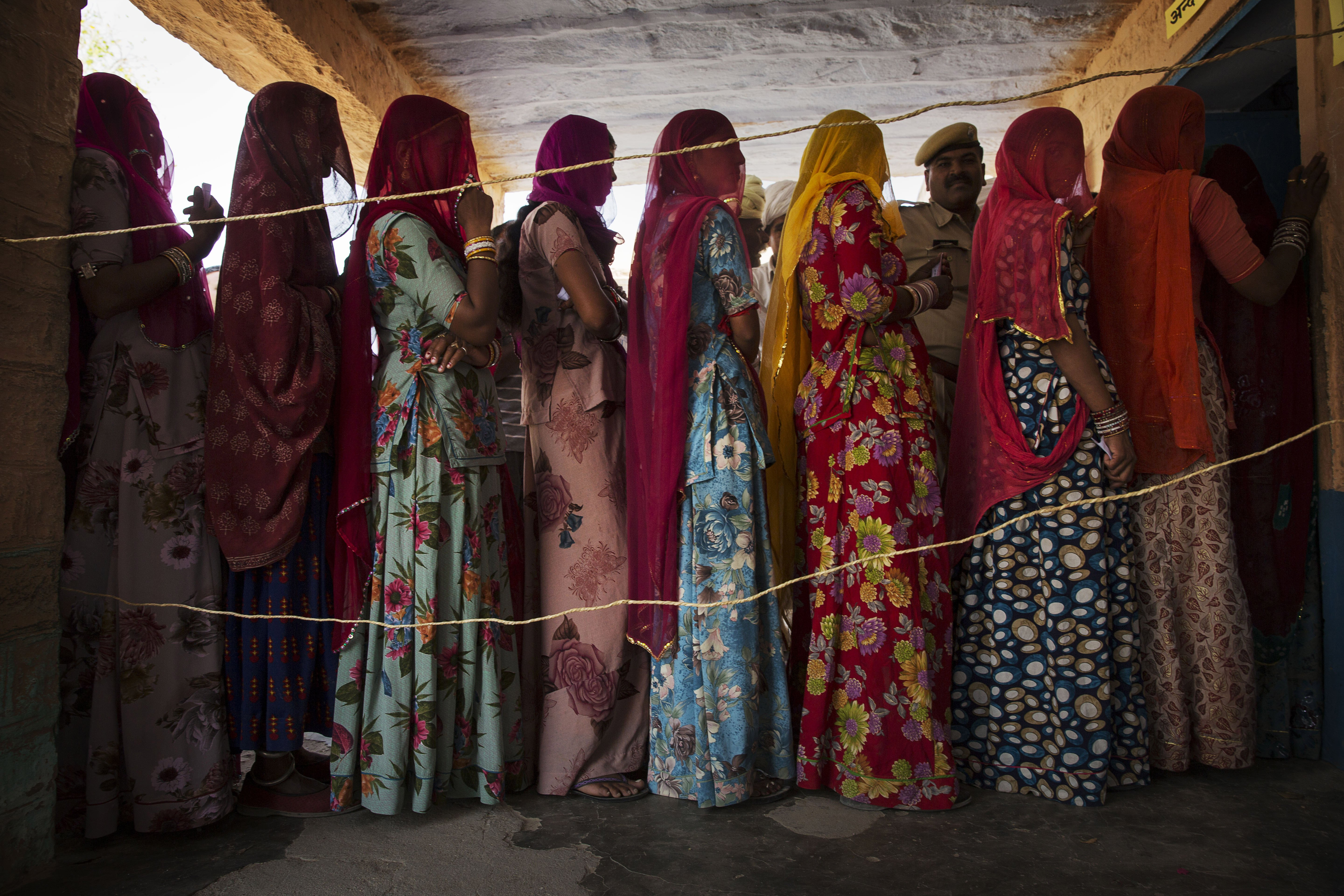 Women wait to vote at a polling station on April 17, 2014 in the Jodhpur District in the desert state of Rajasthan.