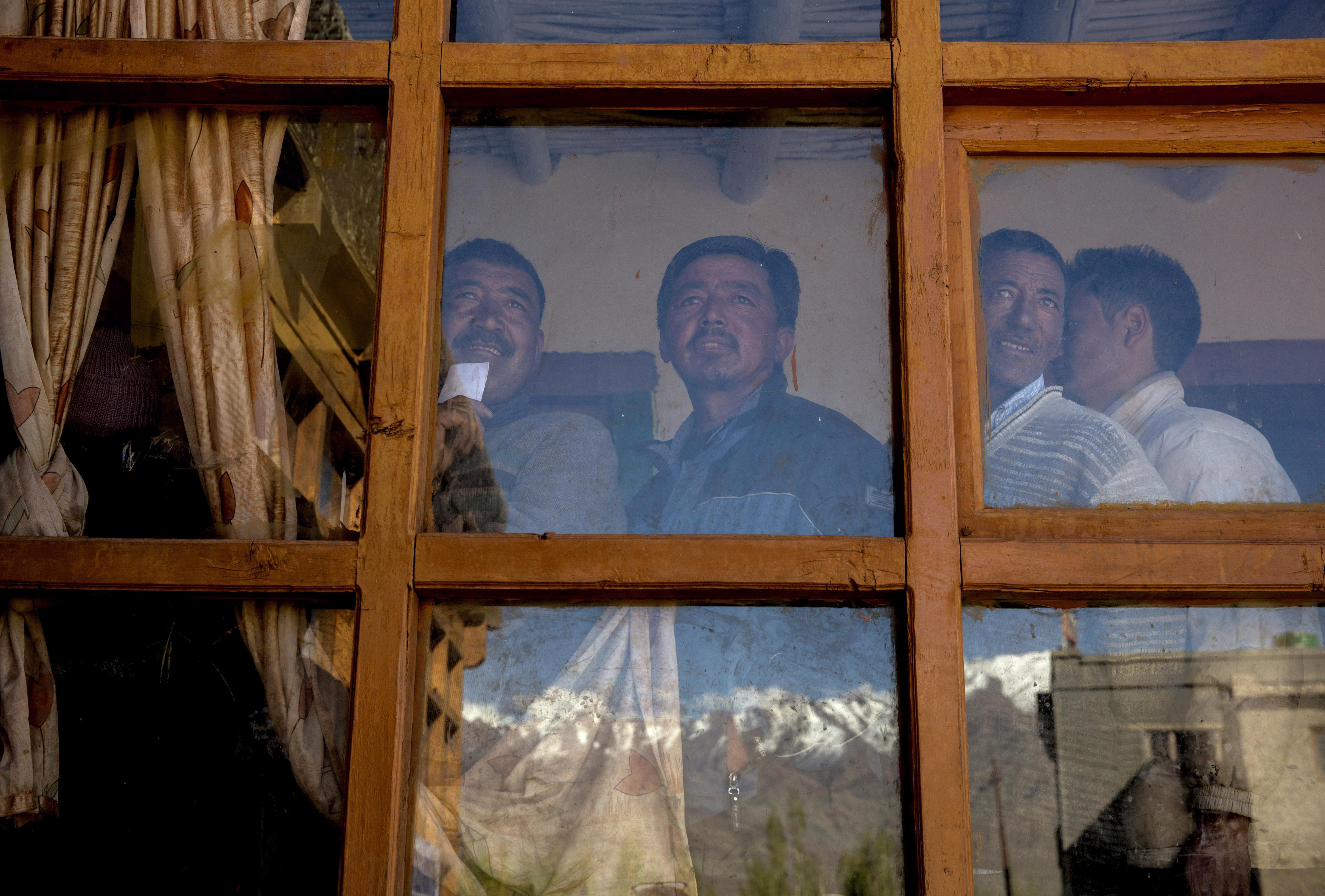 Ladkahis wait inside a polling station to vote near the Thiksey  Monastery on May 7, 2014 in Thiksey, Ladakh.