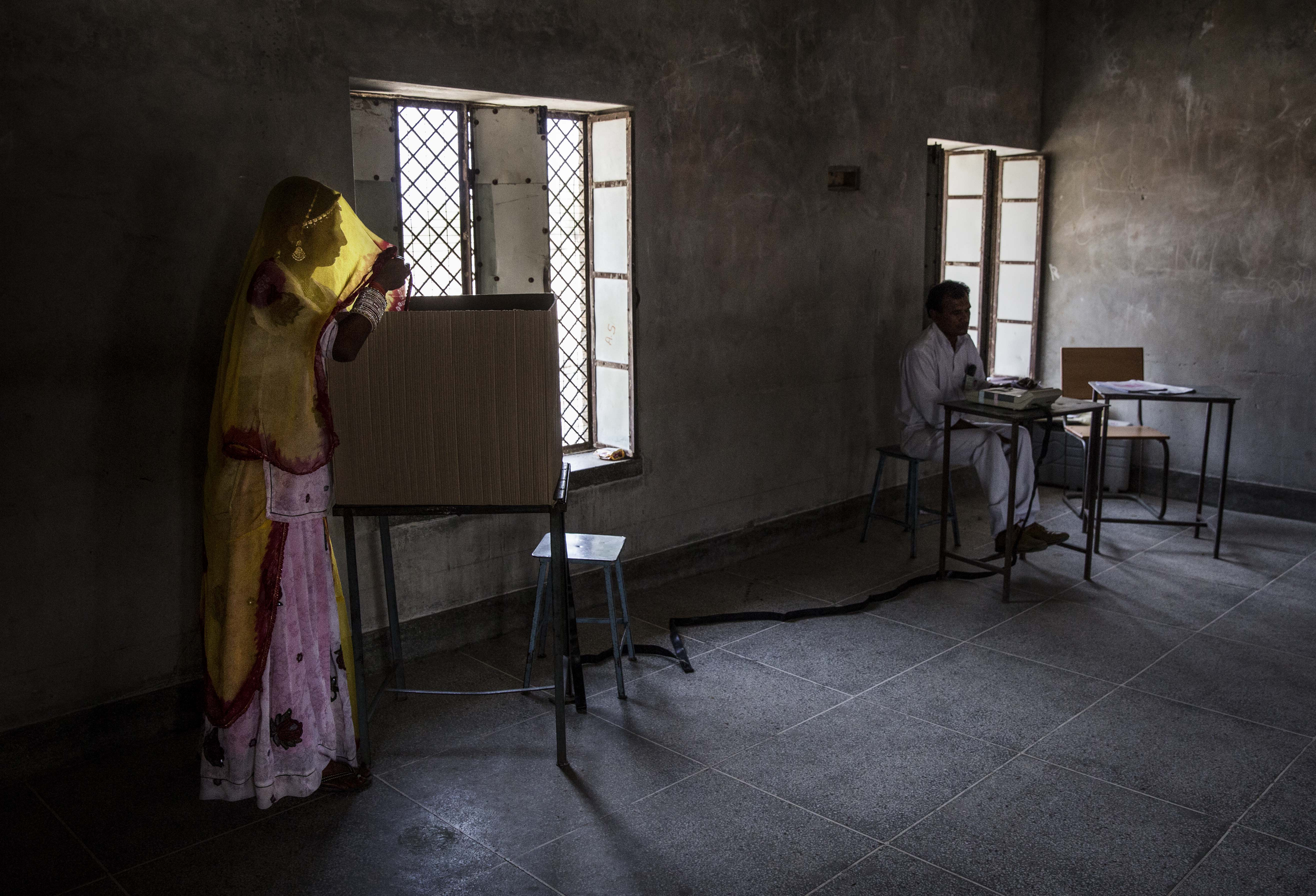 A woman casts her ballot at a polling station on April 17, 2014 in the Jodhpur District in the desert state of Rajasthan.
