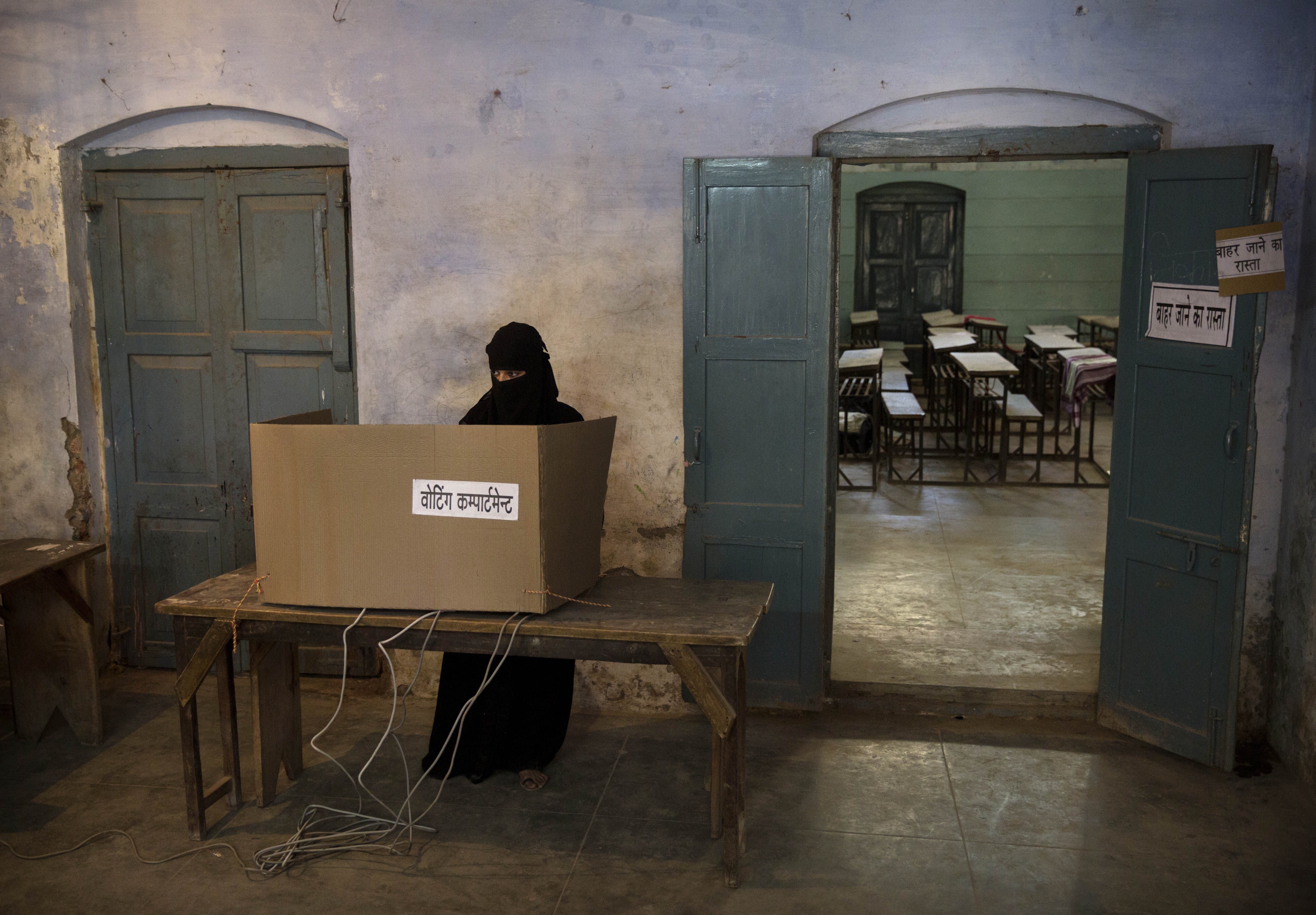 A Muslim woman votes at a polling station on May 12, 2014 in Varanasi.