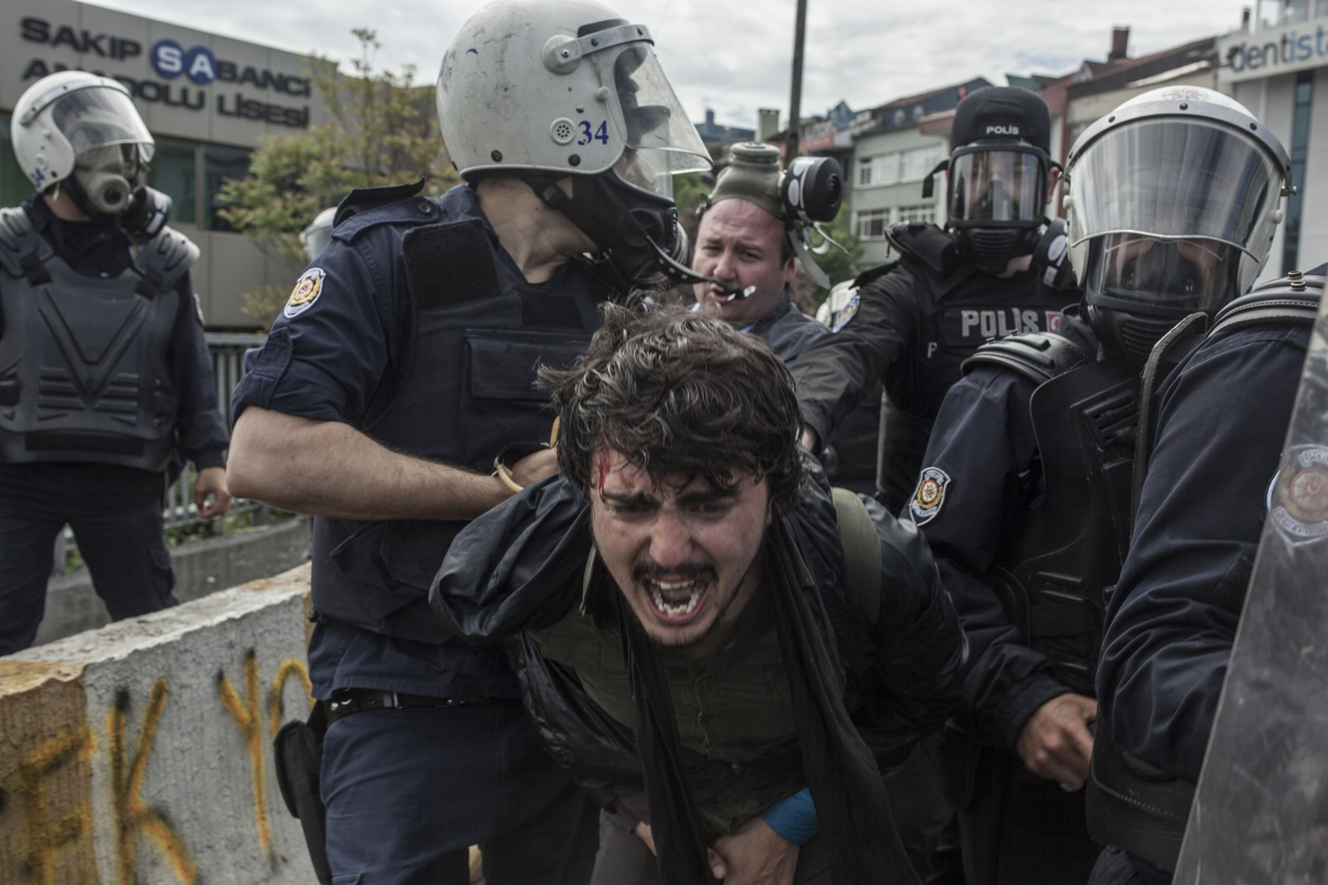A protester is being taken into custody during the protest in Istanbul, May 1, 2014.