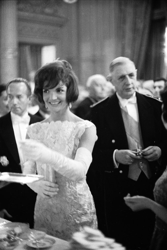 U.S. First Lady Jackie Kennedy attends a luncheon with French President Charles DeGaulle (right) on June 2, 1961 in Washington, D.C.