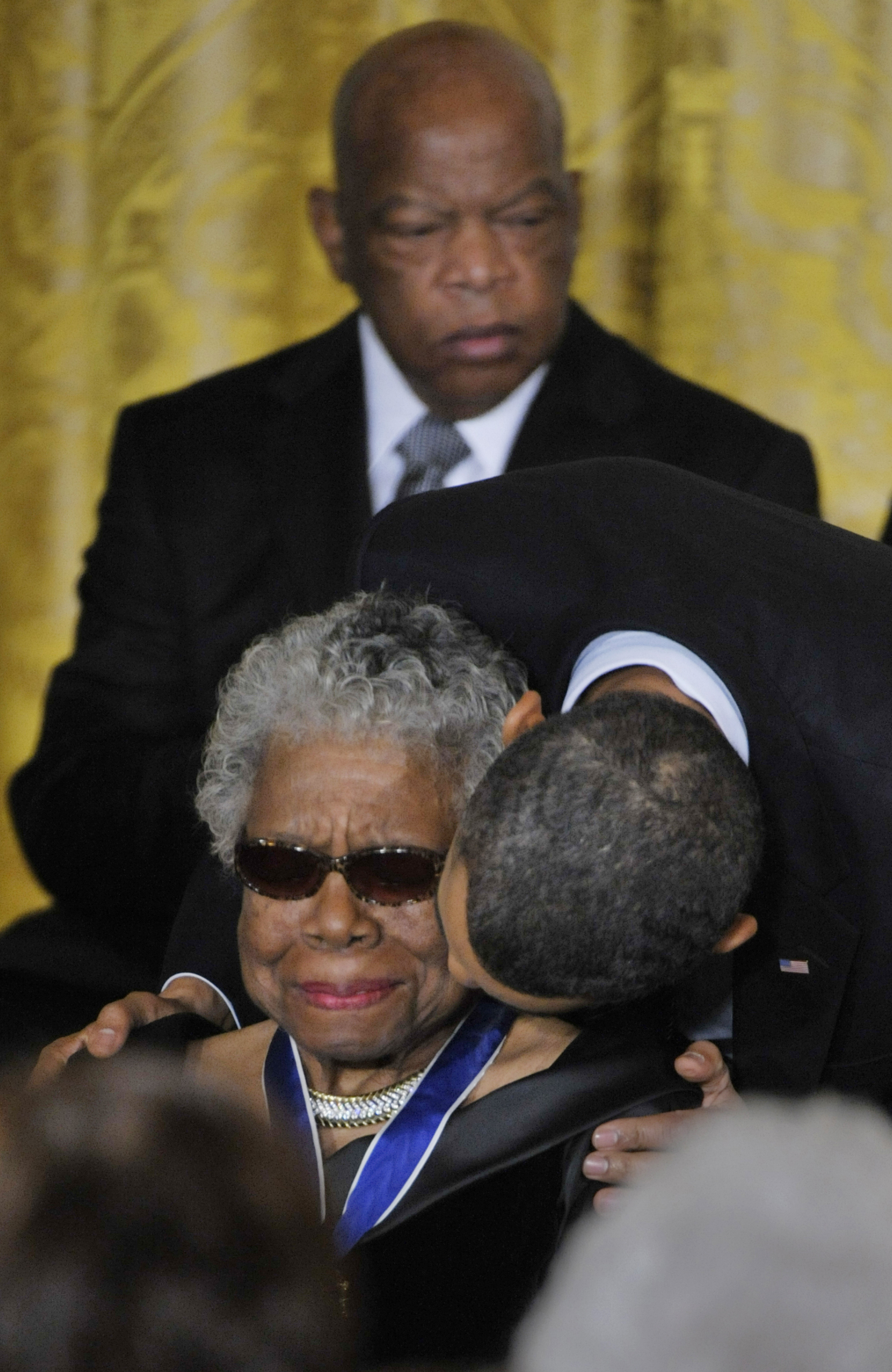 President Obama awards Poet Maya Angelou with the Medal of Freedom as well as a kiss on her cheek, with Medal of Freedom recipient Congressman John Lewis (D-GA) at the White House on February 15, 2011 in Washington. (Marvin Joseph—The Washington Post/Getty Images)