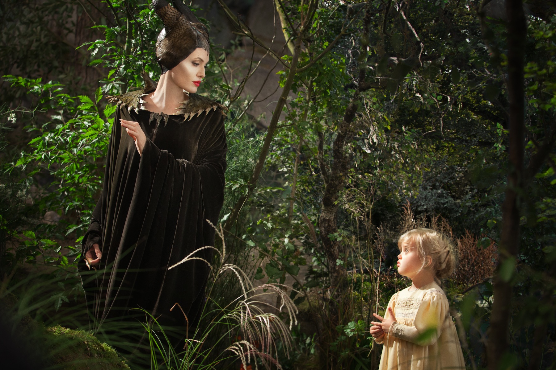 Angelina Jolie as Maleficent, left, in a scene with her daughter Vivienne Jolie-Pitt, portraying Young Aurora, in a scene from  "Maleficent." (Frank Connor / Disney / AP Photo)