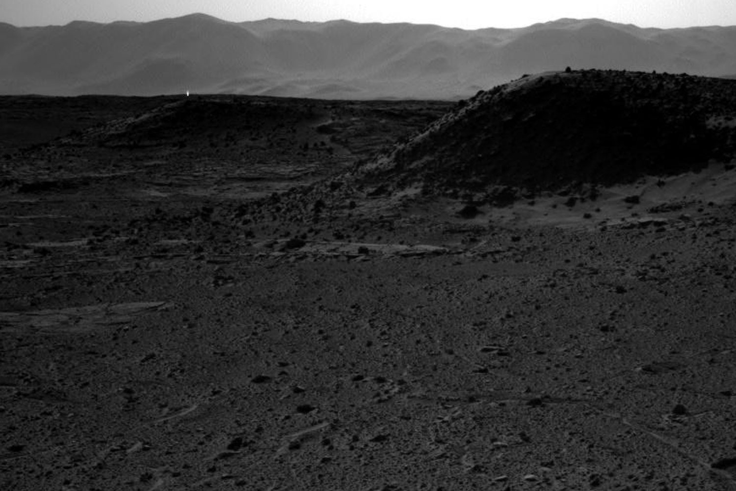 This image taken by the right eye of NASA's Curiosity Mars rover's stereoscopic camera, on April 3, 2014, includes a bright spot, upper left, which might be due to the sun glinting off a rock or cosmic rays striking the camera's detector. Bright spots appear in images from the rover nearly every week.