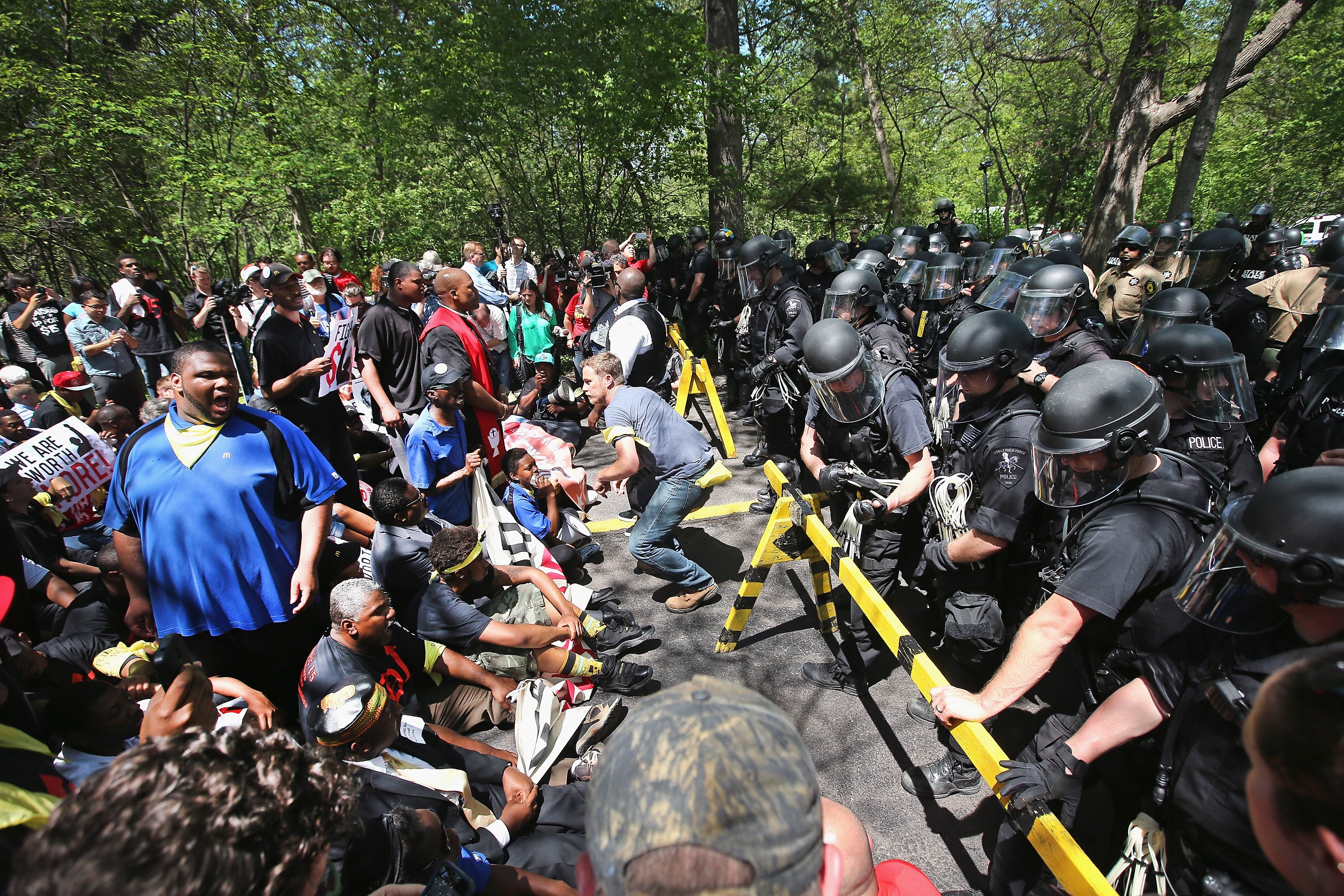 Police hold back fast food workers and activists demonstrating at the McDonald's corporate campus on May 21, 2014 in Oak Brook, Ill. (Scott Olson—Getty Images)