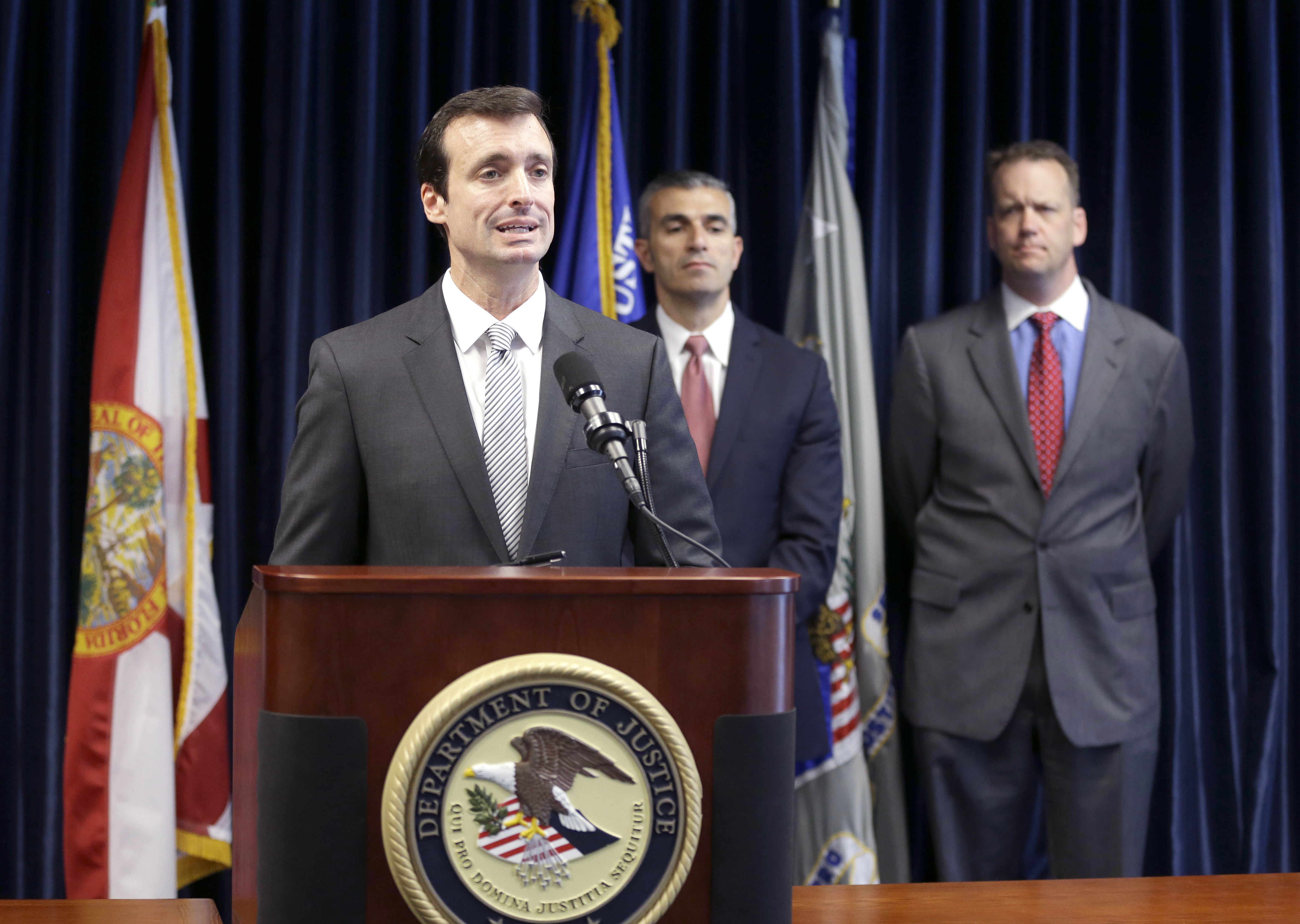 Wifredo Ferrer, left, U.S. Attorney for the Southern District of Florida, announces the arrest of 90 individuals in a Medicare fraud sting operation on May 13, 2014 in Miami. (AP)