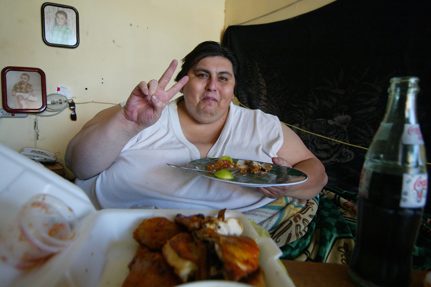 Manuel Uribe eats in his bed at home in Monterrey, Mexico, January 19, 2006. (Luis Reyes / Reuters)