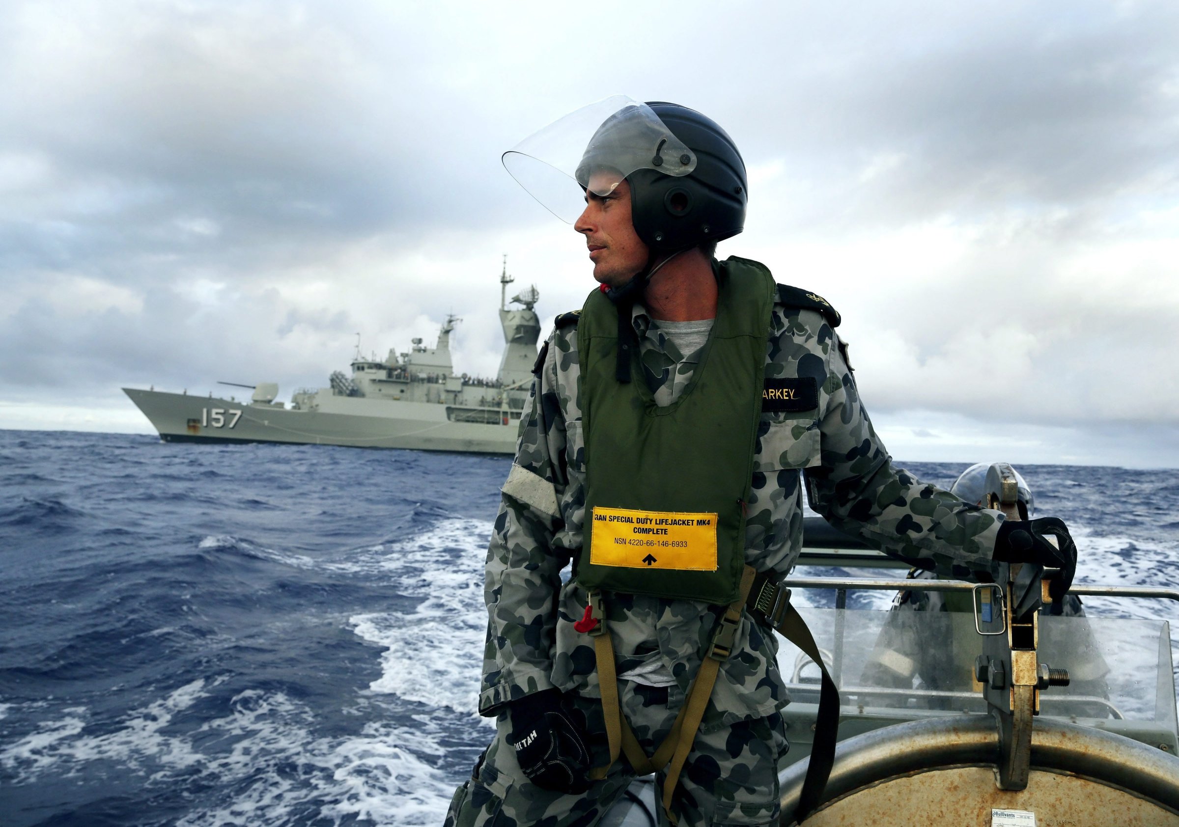 Leading Seaman, Boatswain's Mate, William Sharkey searches for debris at sea in the Southern Indian Ocean on April 6, 2014.
