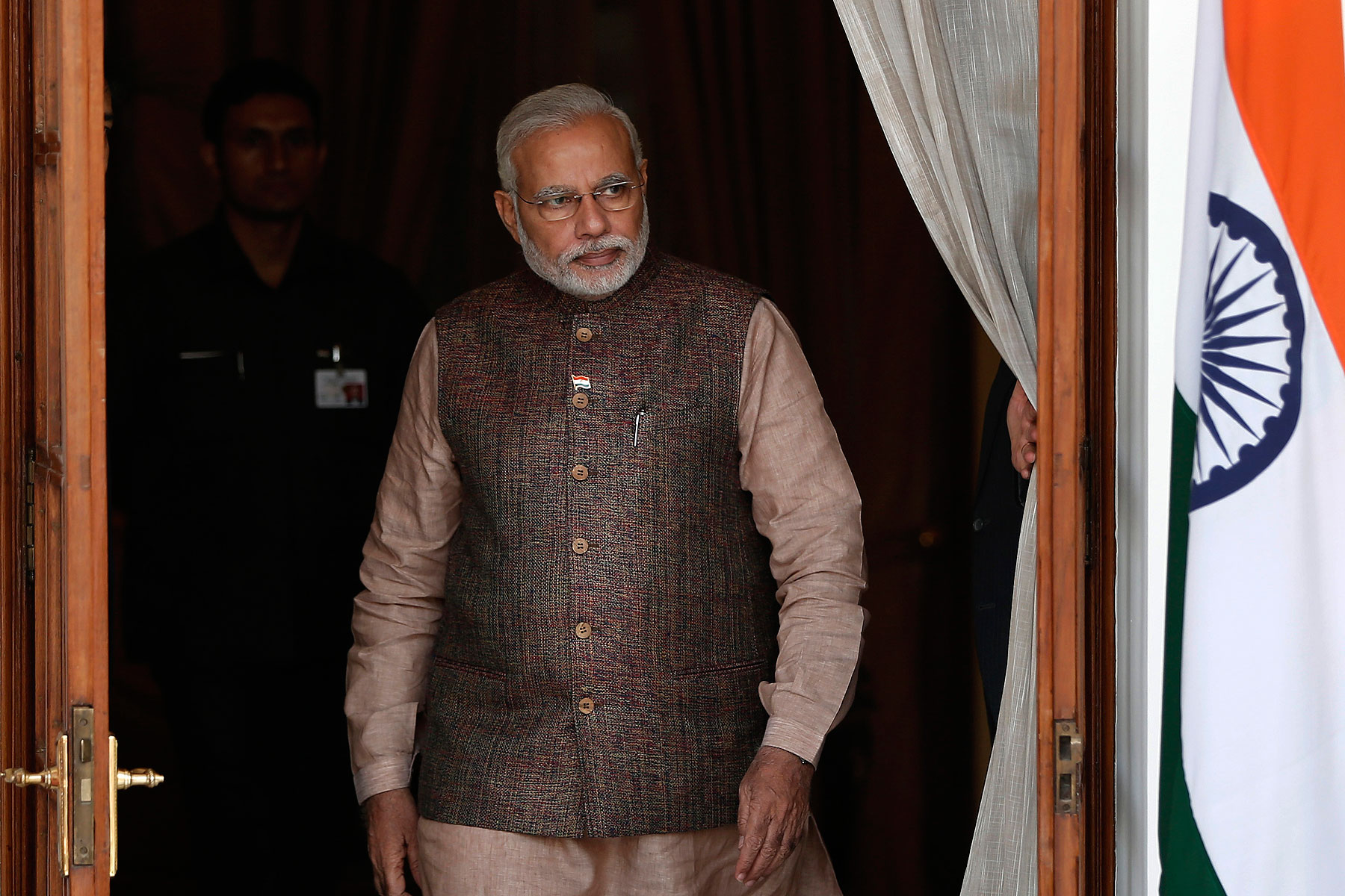 India's Prime Minister Narendra Modi comes out of a meeting room to receive his Bhutanese counterpart Tshering Tobgay before the start a bilateral meeting in New Delhi on May 27, 2014 (Adnan Abidi—Reuters)