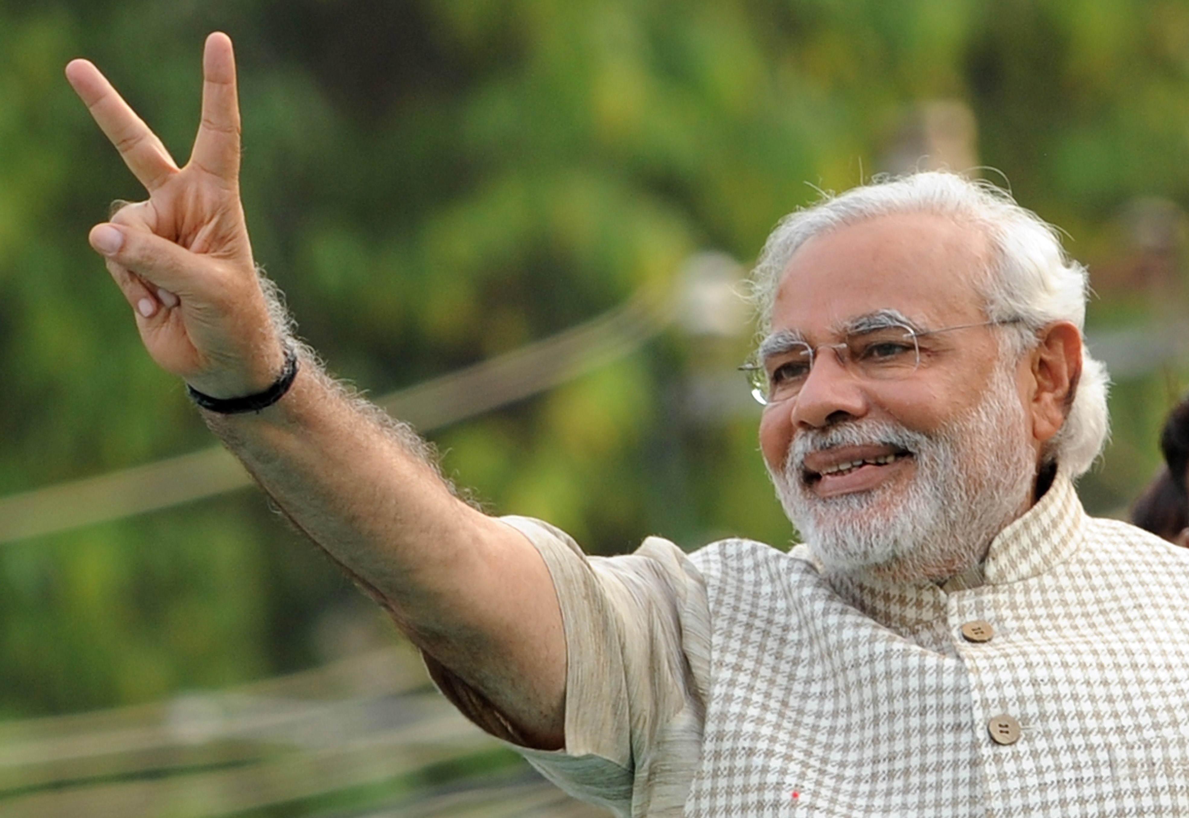 Chief Minister of western Gujarat state and main opposition Bharatiya Janata Party (BJP) prime ministerial candidate Narendra Modi flashes the victory sign as he arrives at a public rally after his victory in Vadodara on May 16, 2014.