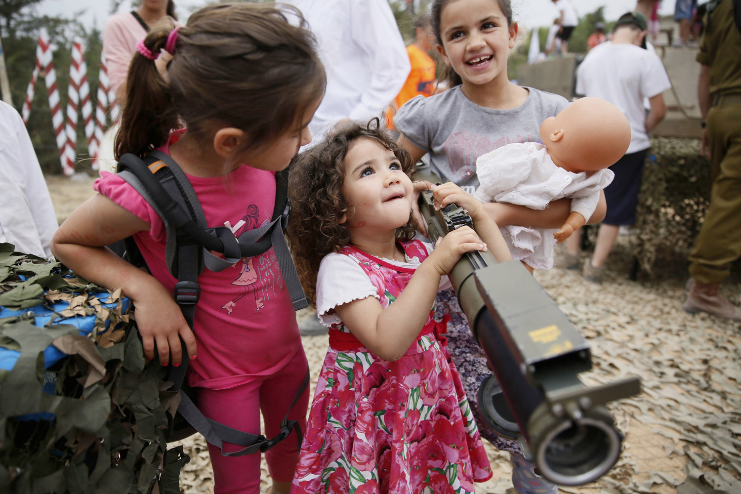 An Israeli child holds a rocket launcher during a traditional military weapon display to mark the 66th anniversary of Israel's Independence at the West Bank settlement of Efrat near the biblical city of Bethlehem on May 6, 2014.