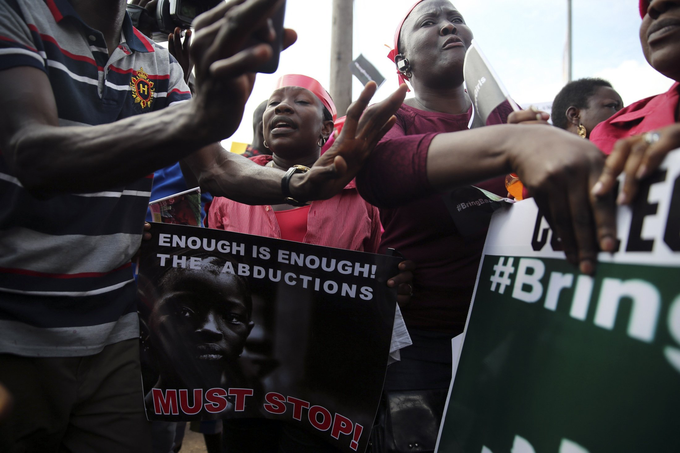 People holding signs take part in a protest demanding the release of abducted secondary school girls from the remote village of Chibok, in Lagos, May 5, 2014.