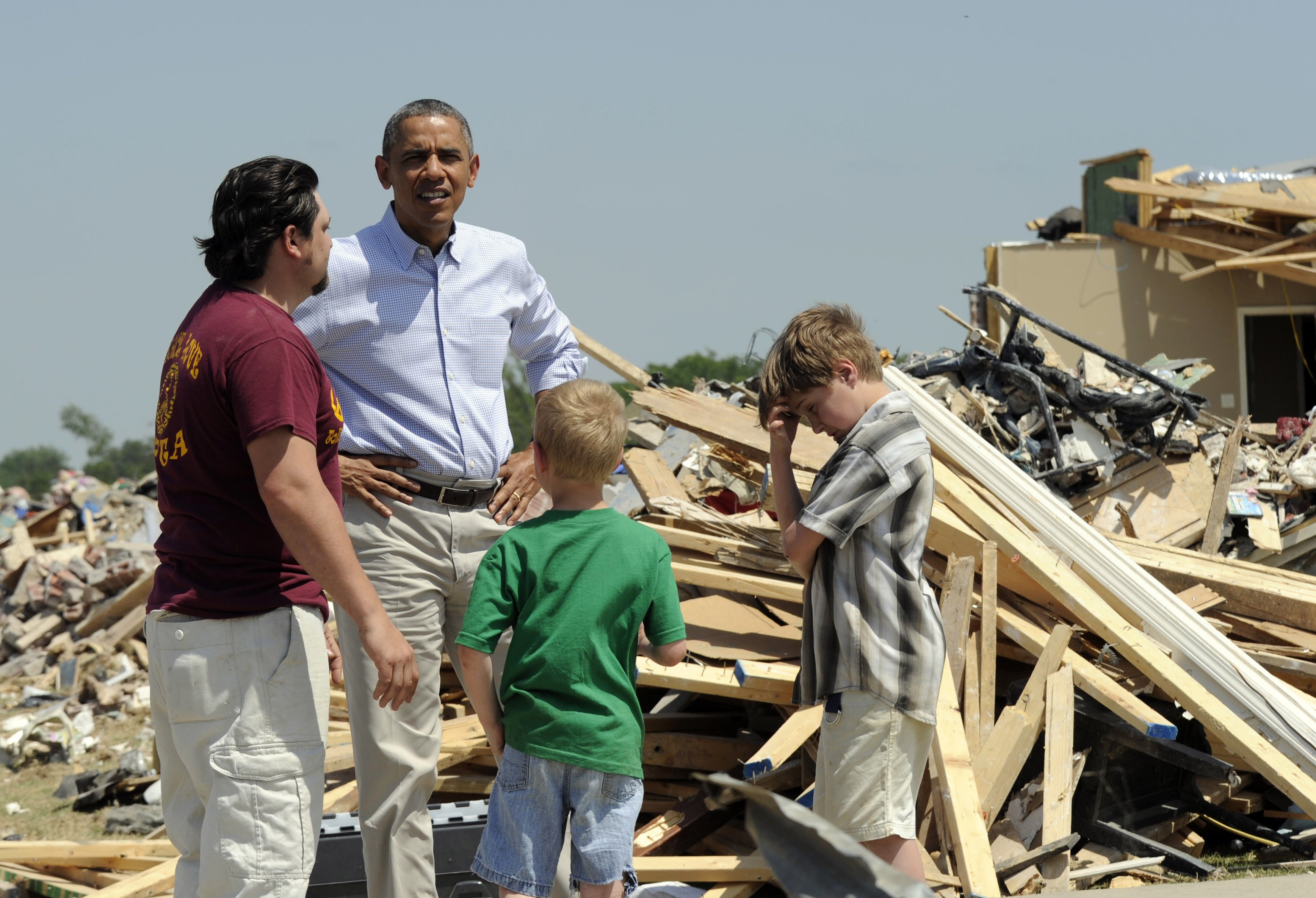 President Barack Obama tours tornado-damaged areas and talks with Daniel Smith and his sons Garrison Dority and Gabriel Dority in Vilonia, Ark. on May 7, 2014. (Susan Walsh—AP)