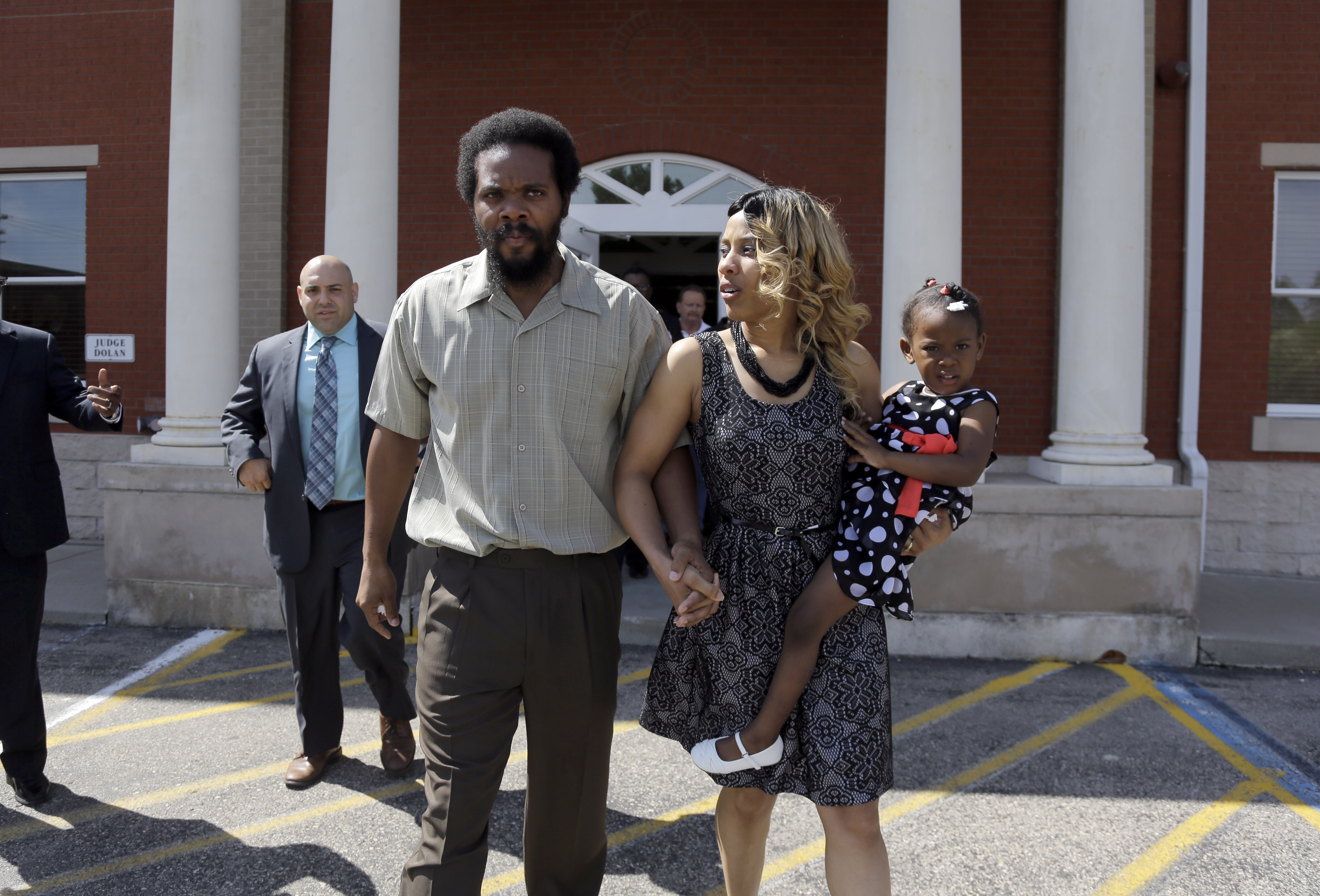 Cornealious "Mike" Anderson walks out of the Mississippi County Courthouse along with his wife LaQonna Anderson, right, their daughter Nevaeh, 3, and his attorney Patrick Megaro, left, Monday, May 5, 2014, in Charleston, Mo. (Jeff Roberson—AP)