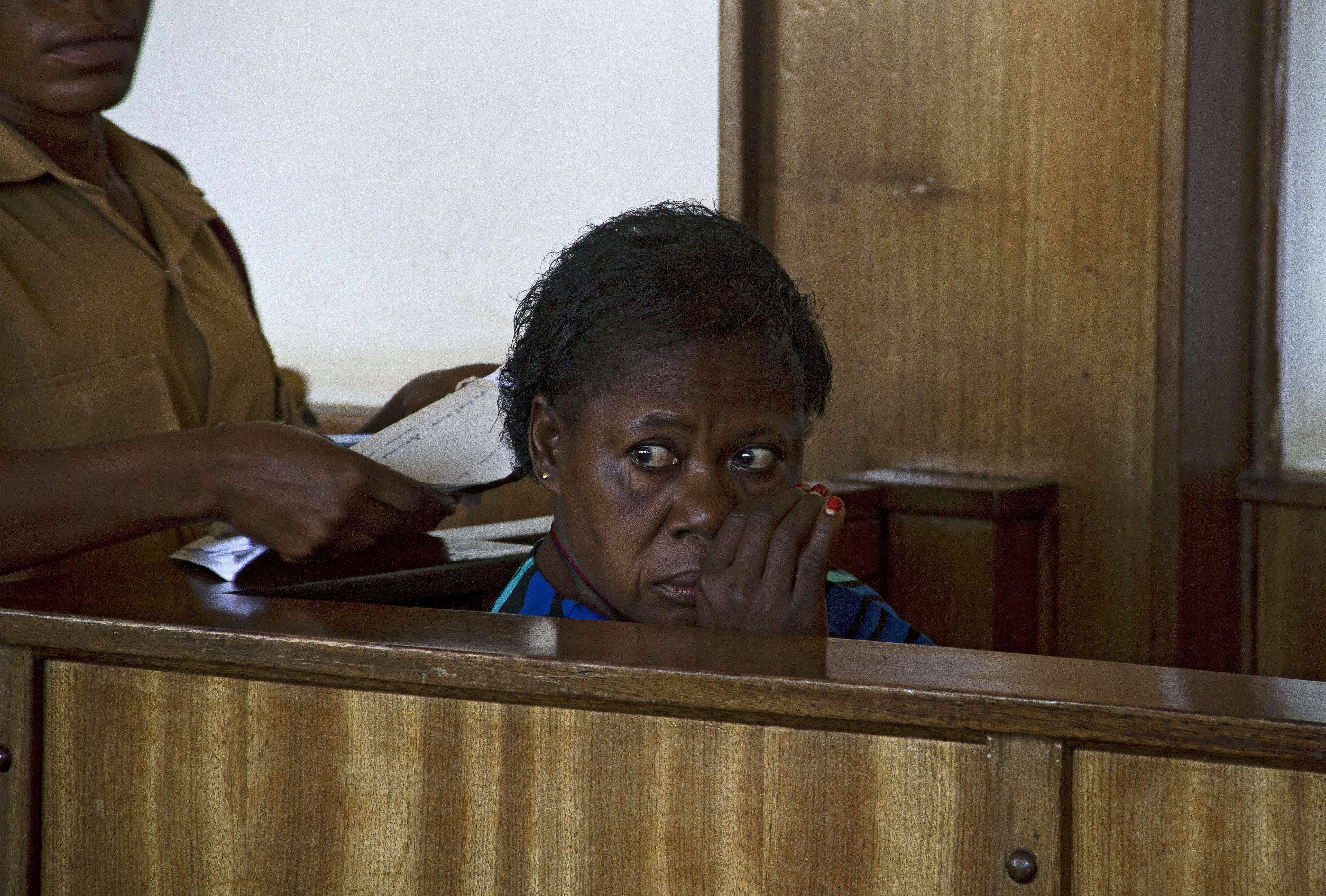 Ugandan nurse Rosemary Namubiru sits at the dock at the Buganda Road Magistrates Court on May 19, 2014 in Kampala during a ruling on a case where she was charged with "Criminal Negligence" and sentenced to 3 years in prison after she was found guilty by the Ugandan court. (Isaax Kasamni—AFP/Getty Images)