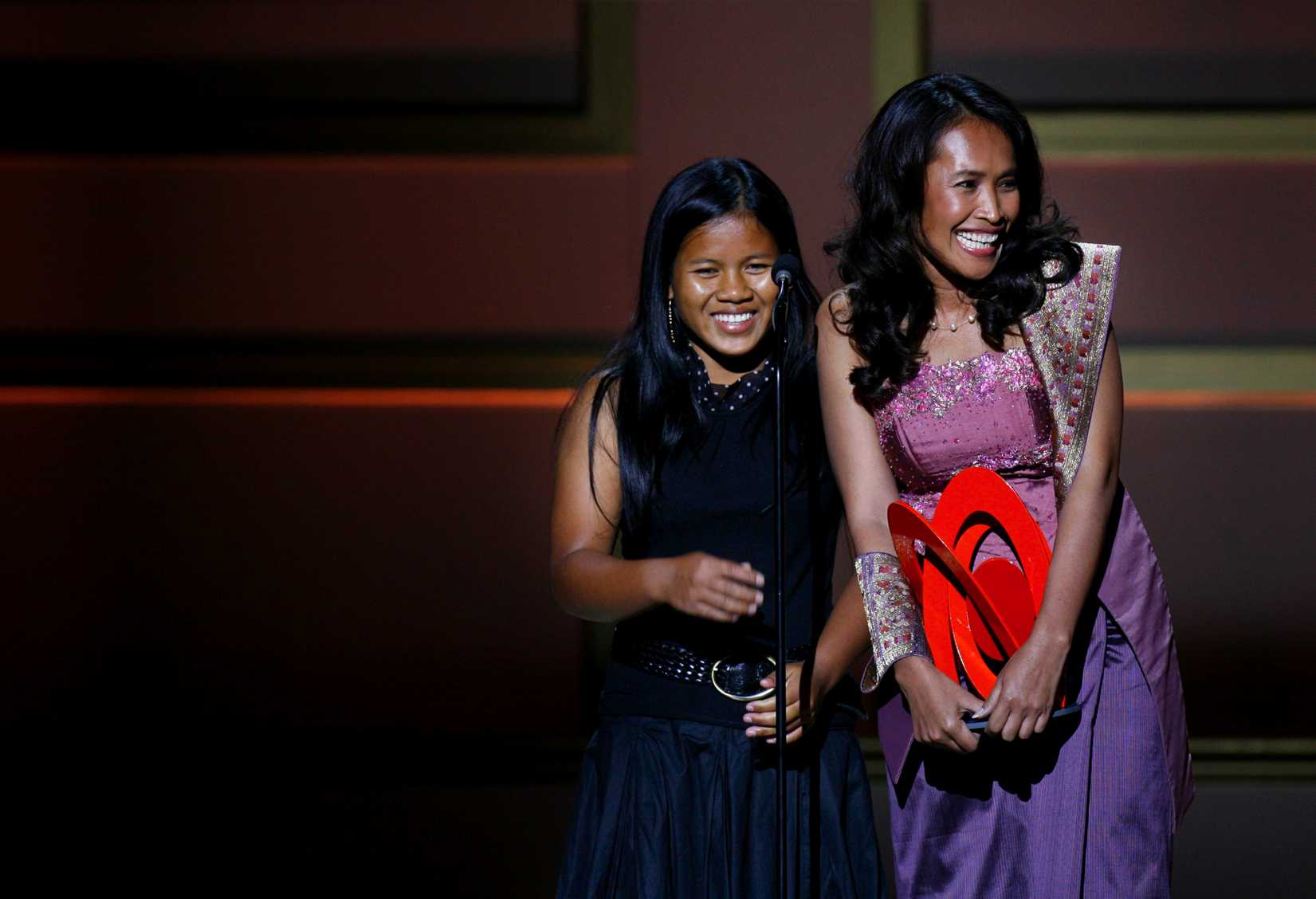 Cambodian activist Somaly Mam (R) accepts a "Woman of the Year" award with a child she rescued from sexual slavery, during the 2006 Glamour Magazine "Women of the Year" Honors award show in New York City October 30, 2006. (Lucas Jackson—Reuters)