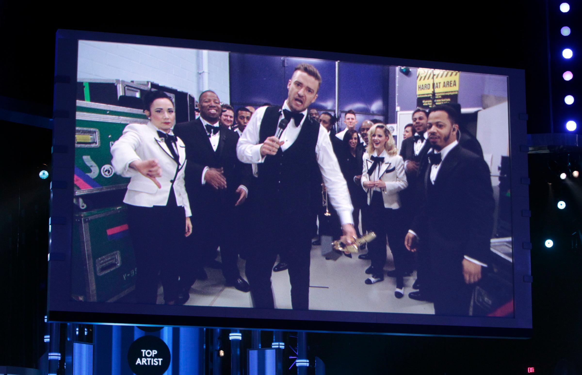Justin Timberlake is shown on a large screen as he accepts the award for Top Artist at the 2014 Billboard Music Awards in Las Vegas