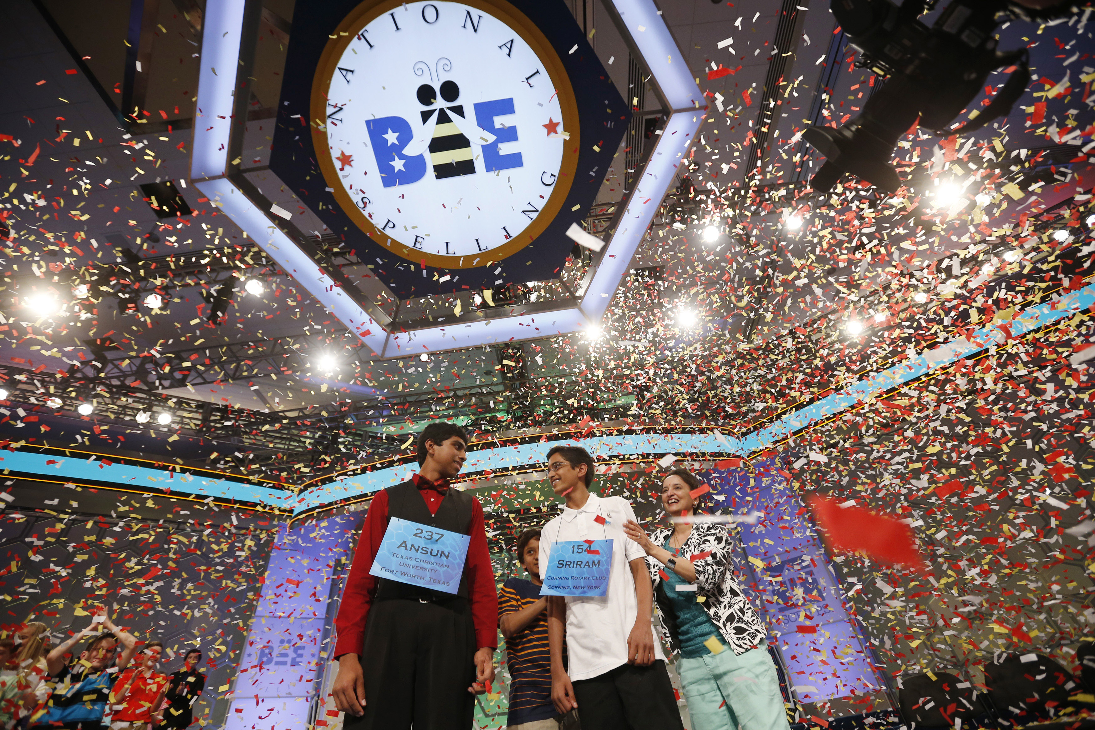 Sriram Hathwar of Painted Post, N.Y., stands next to his mother Roopa, far right, as he and Ansun Sujoe of Fort Worth are named joint winners of the Scripps National Spelling Bee in National Harbor, Md., on May 29, 2014. (Kevin Lamarque—Reuters)