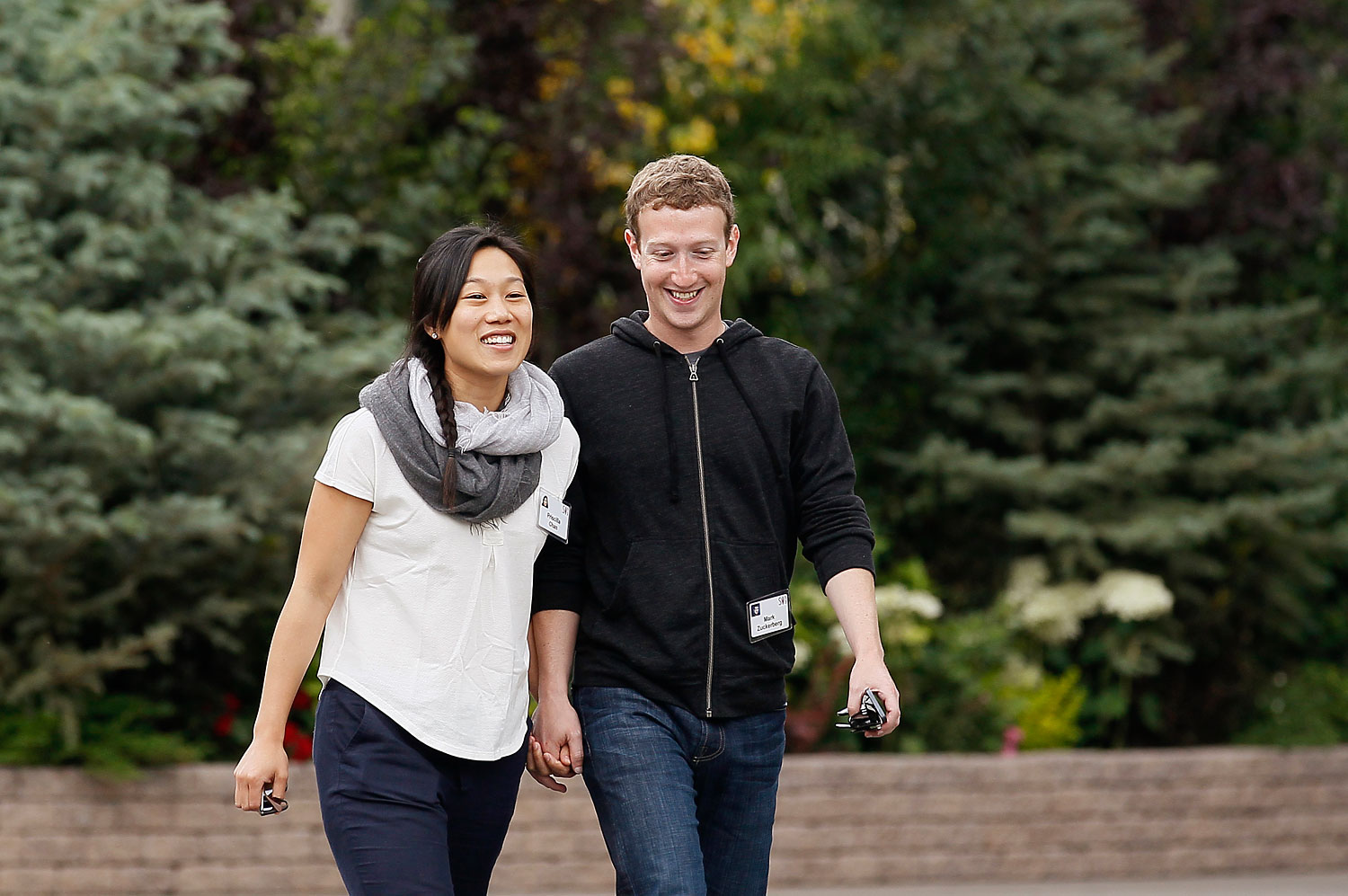 Facebook CEO Zuckerberg walks with wife Priscilla Chan at the annual Allen and Co. conference at the Sun Valley
