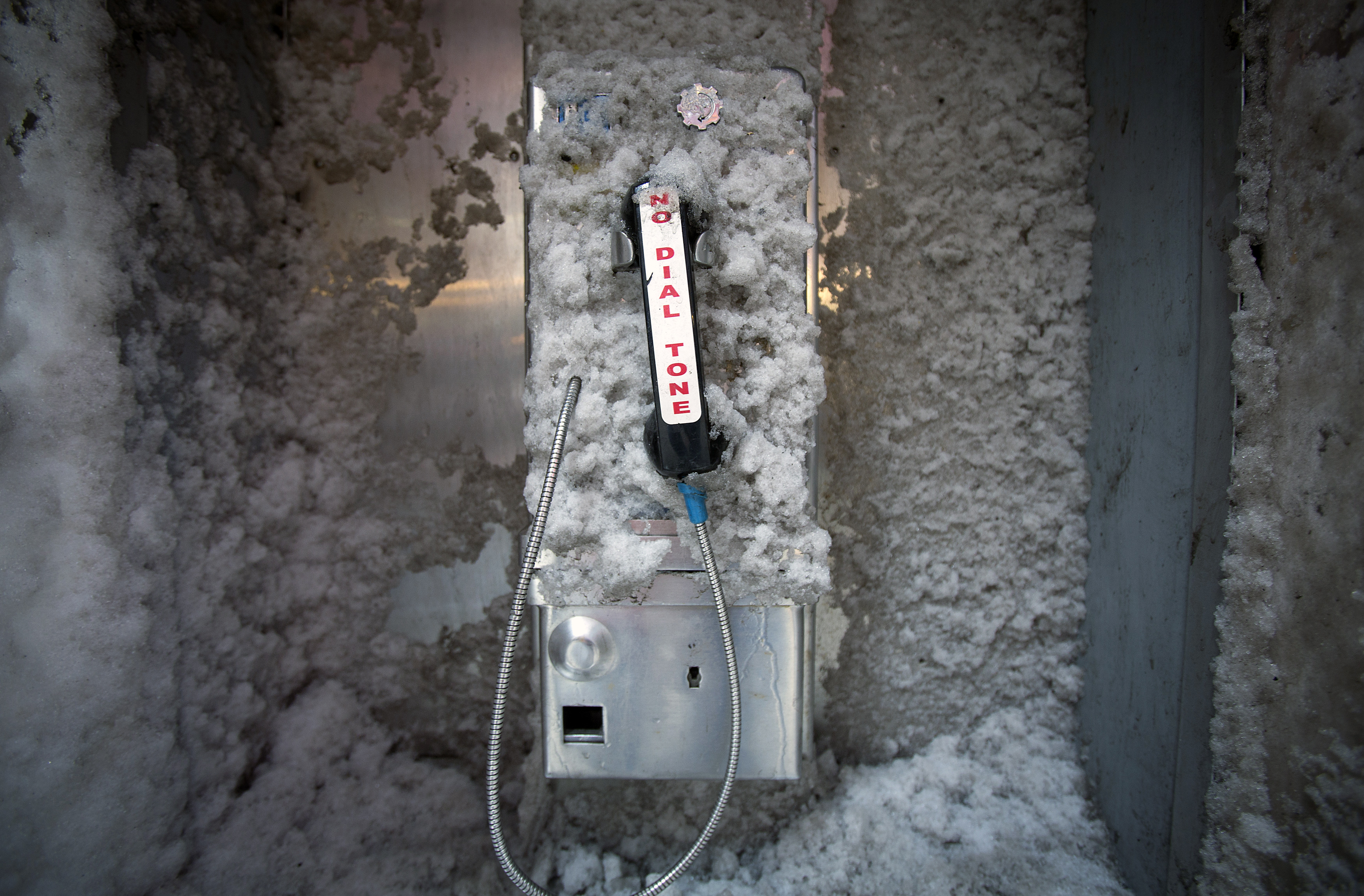A disused pay phone is covered in snow in Times Square in New York