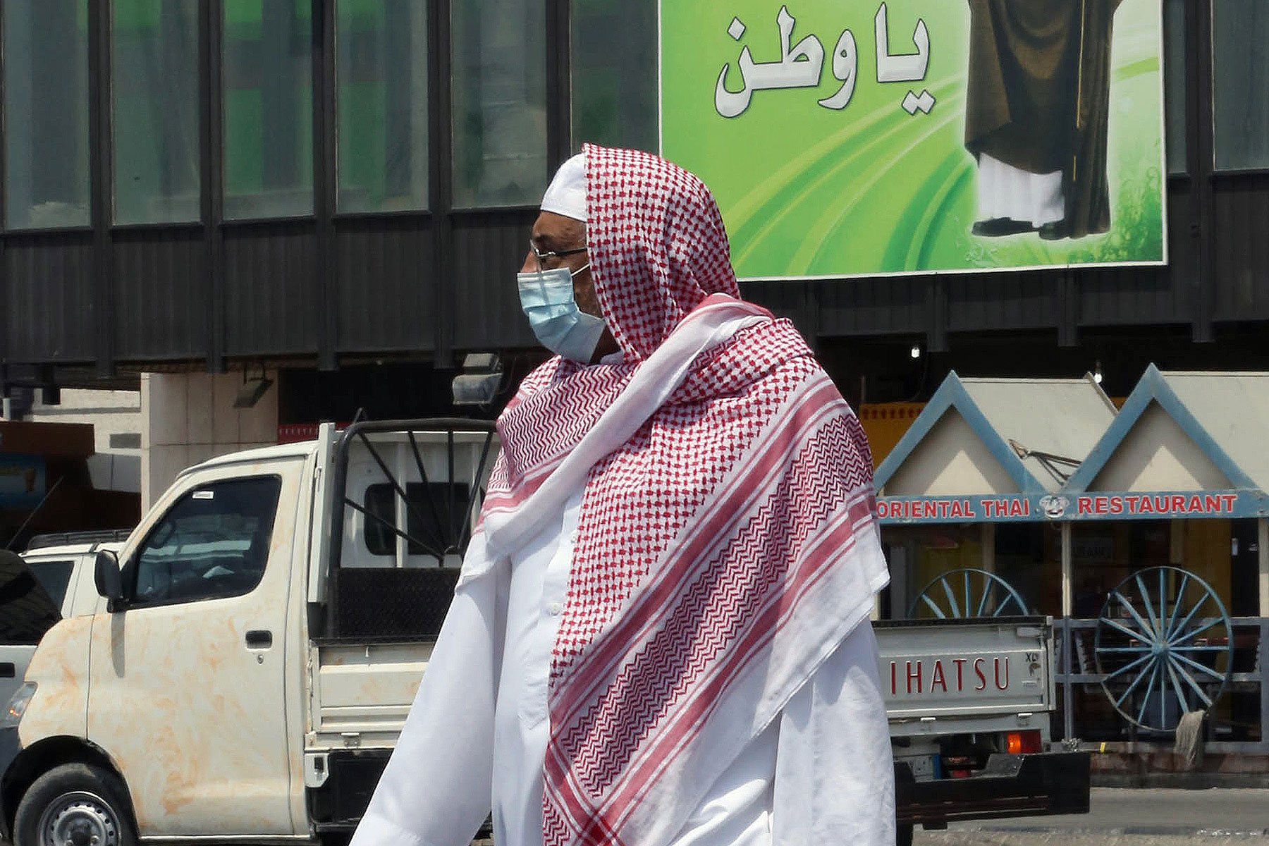 A Saudi man wears a mouth and nose mask as he walks in a street of the Red Sea coastal city of Jeddah on April 27, 2014 (AFP/Getty Images)