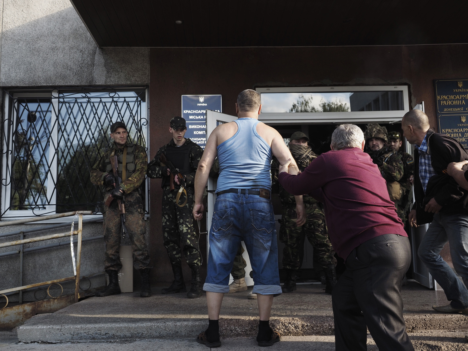 May 11, 2014. A man upset for not being able to vote in the illegal referendum confronts armed guards outside the polling location.