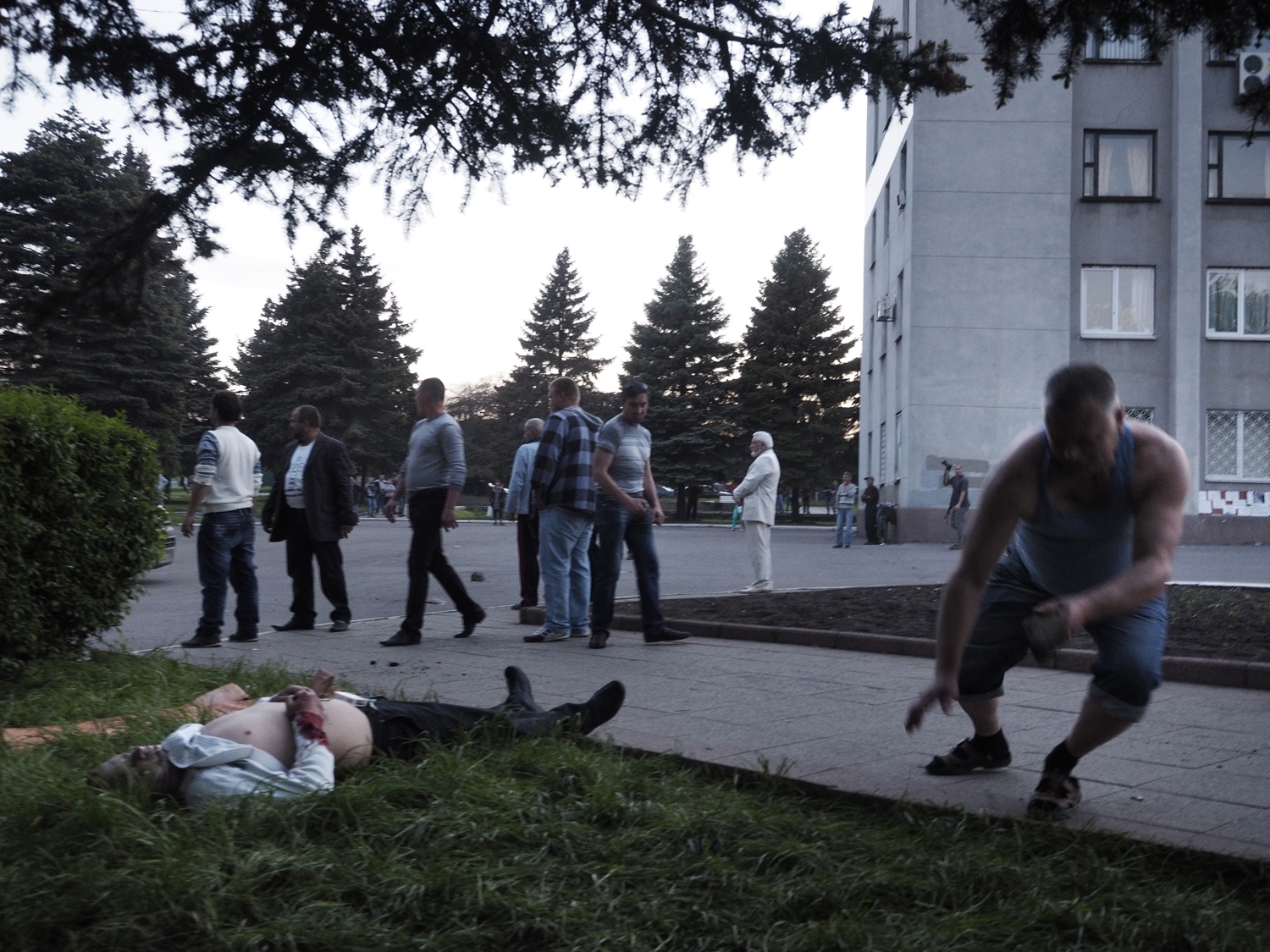 May 11, 2014. The man begins to collapse after being struck by a bullet.