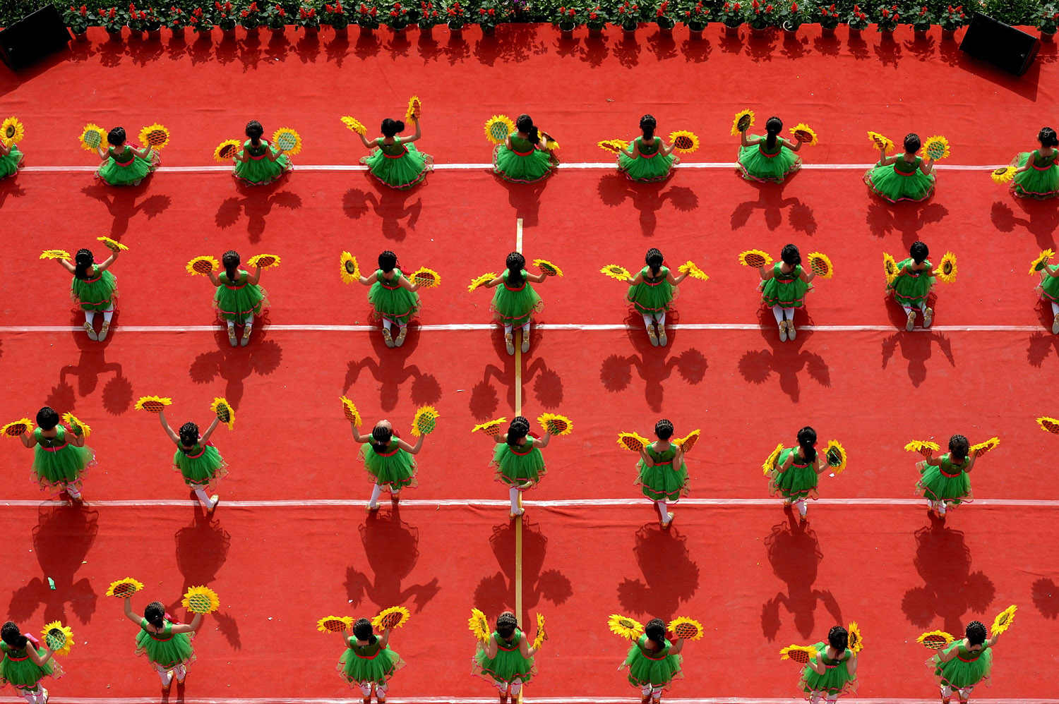 Pupils dance to celebrate the upcoming Children's Day in Xuan'en County, central China's Hubei Province, May 28, 2014.