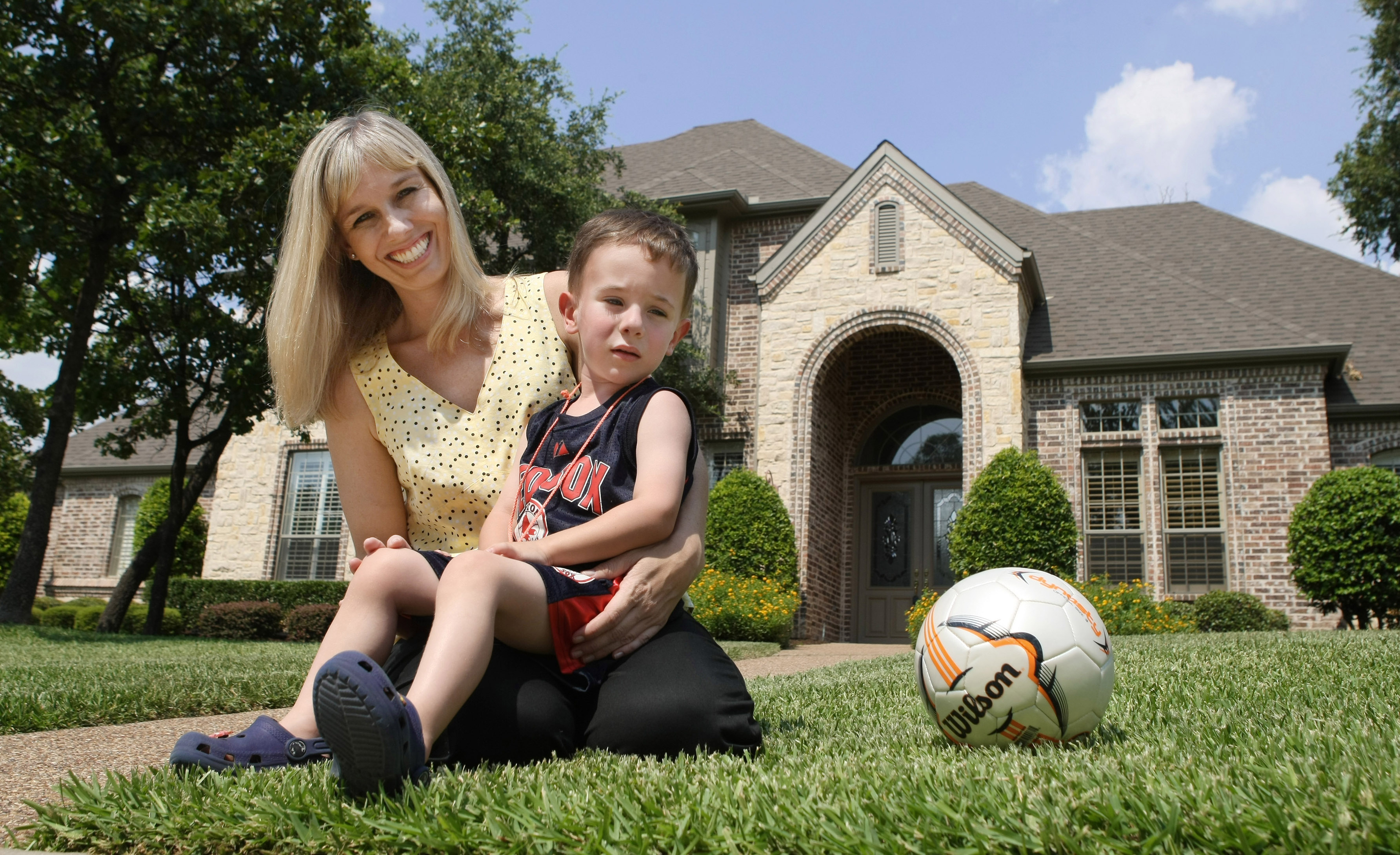 Kelly McGuire Lynch poses at her soon-to-be ex-home in Southlake, Texas, with her son Patrick, June 24, 2009. (MCT—Getty Images)