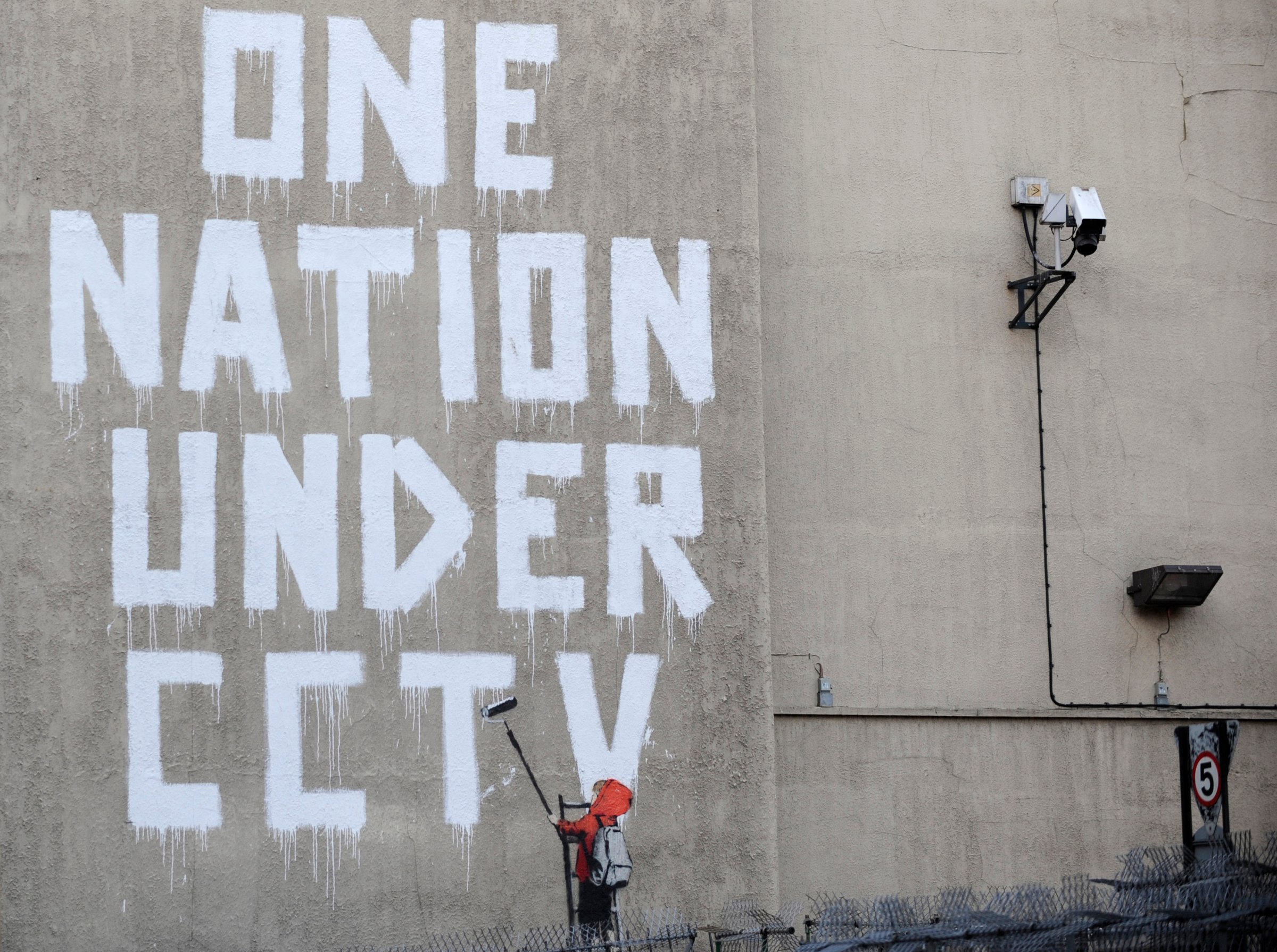 Street graffiti by elusive graffiti artist Banksy is seen on a wall in central London