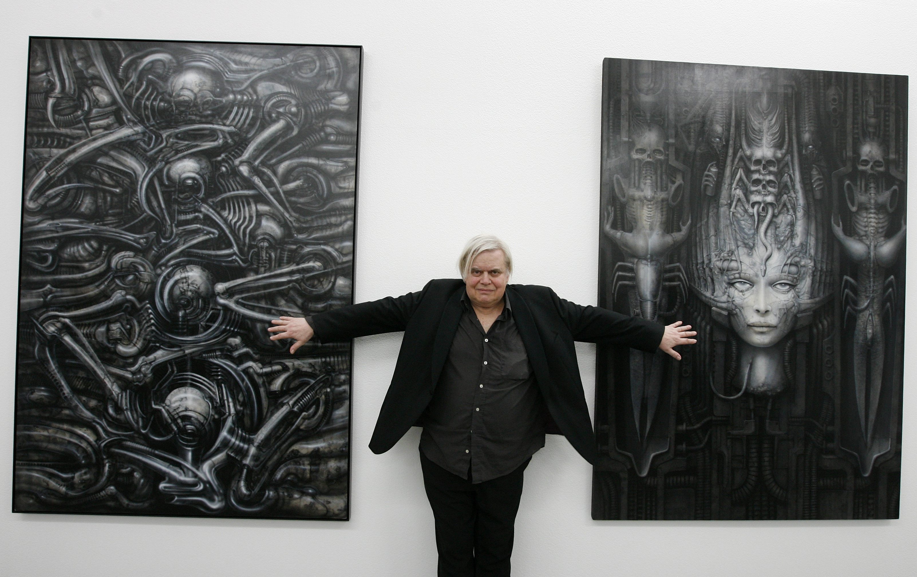 Swiss artist H.R. Giger  poses with two of his works at the art museum in Chur, Switzerland. (John Moore—Getty Images)