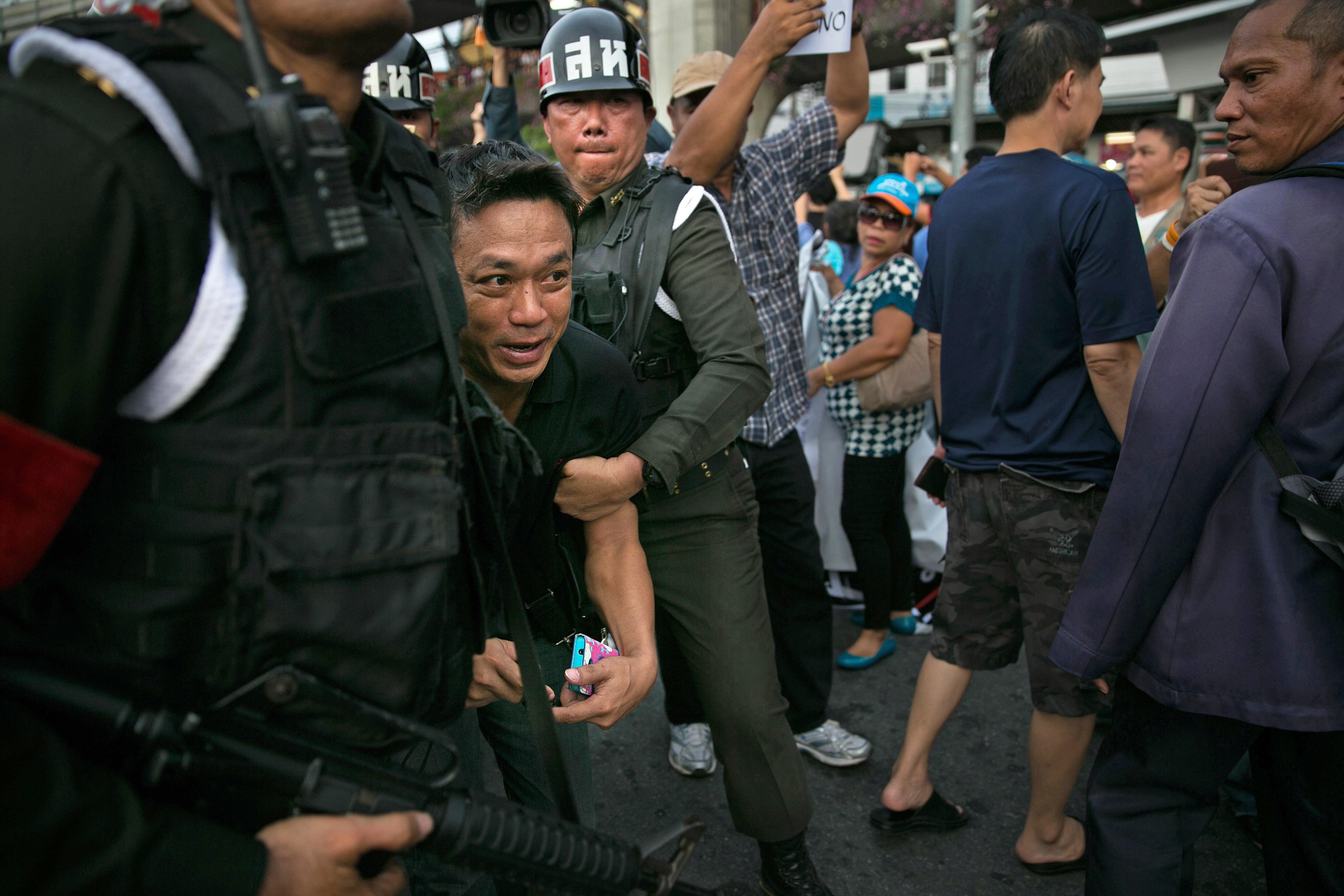 Thai military officers arrest a protester as tensions rise during anti coup protests in Bangkok on May 28, 2014 (Paula Bronstein—Getty Images)