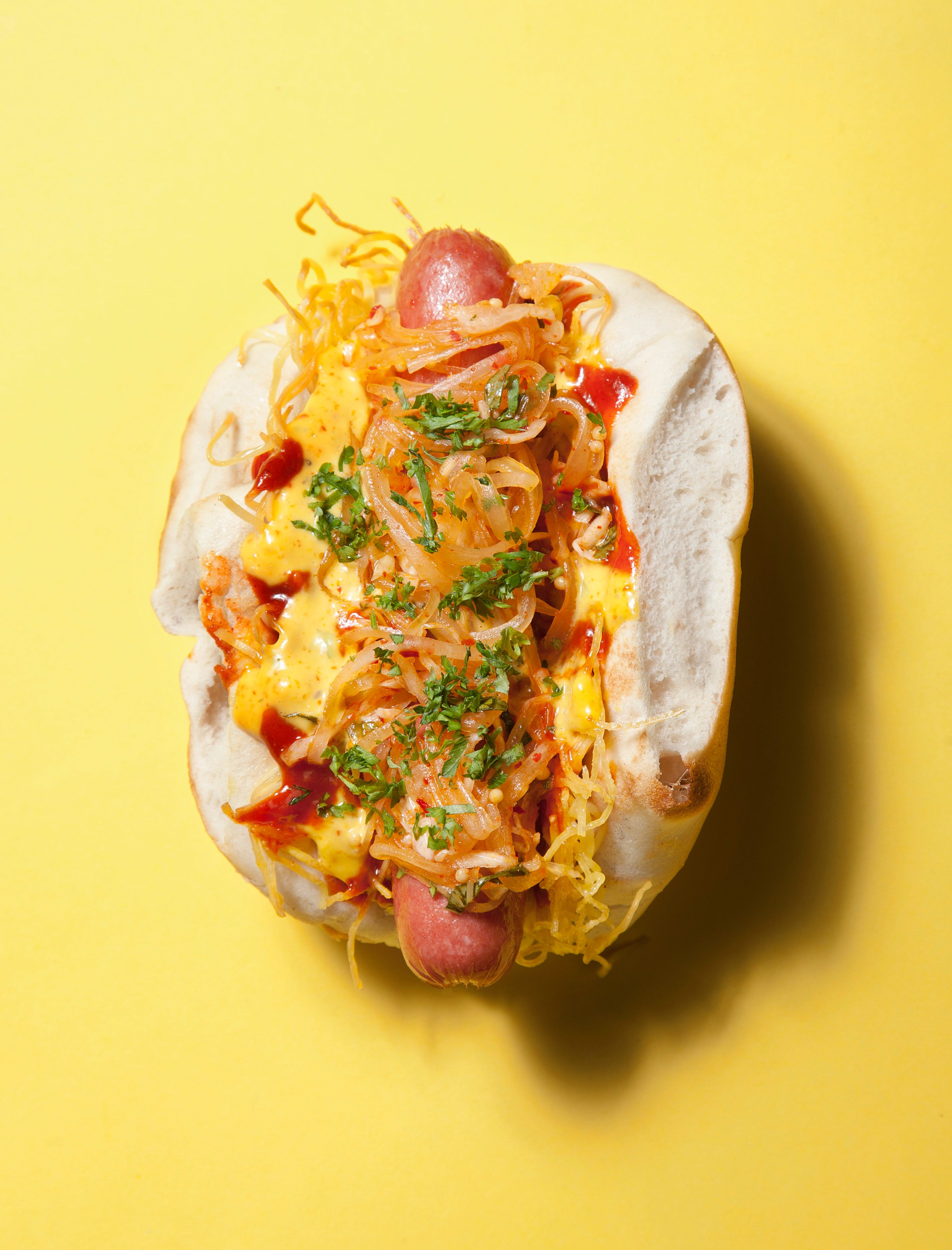 A Belly Dog at Belly Shack in Chicago. Description: An all-beef hot dog, topped with egg noodles and pickled green papaya, with togarashi spiced fries. Photo by Kevin J. Miyazaki/Redux