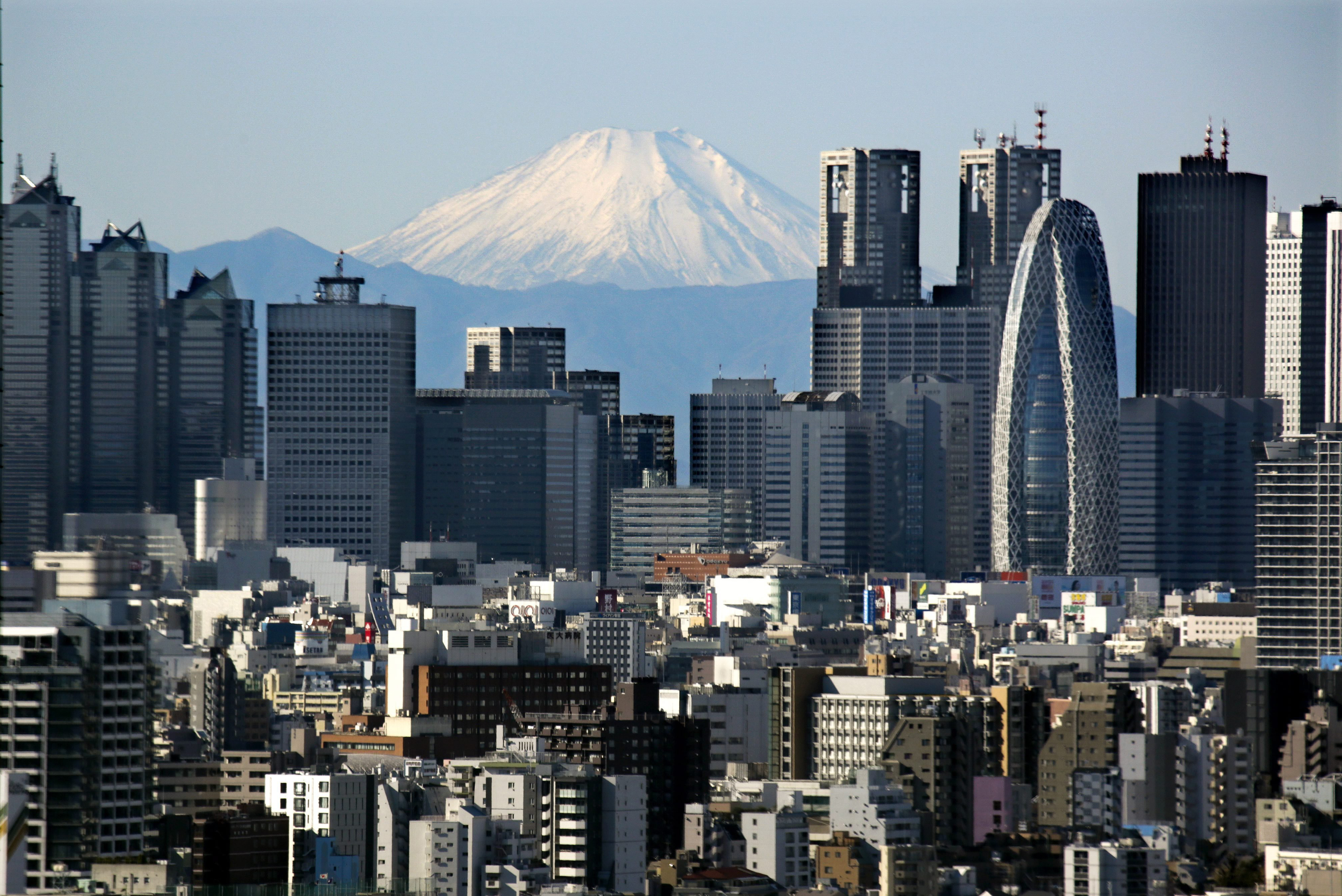 Japan's highest peak of Mt. Fuji and Shinjuku skyscrapers in central Tokyo, on Dec. 16, 2013. (Kimimasa Mayama—EPA)