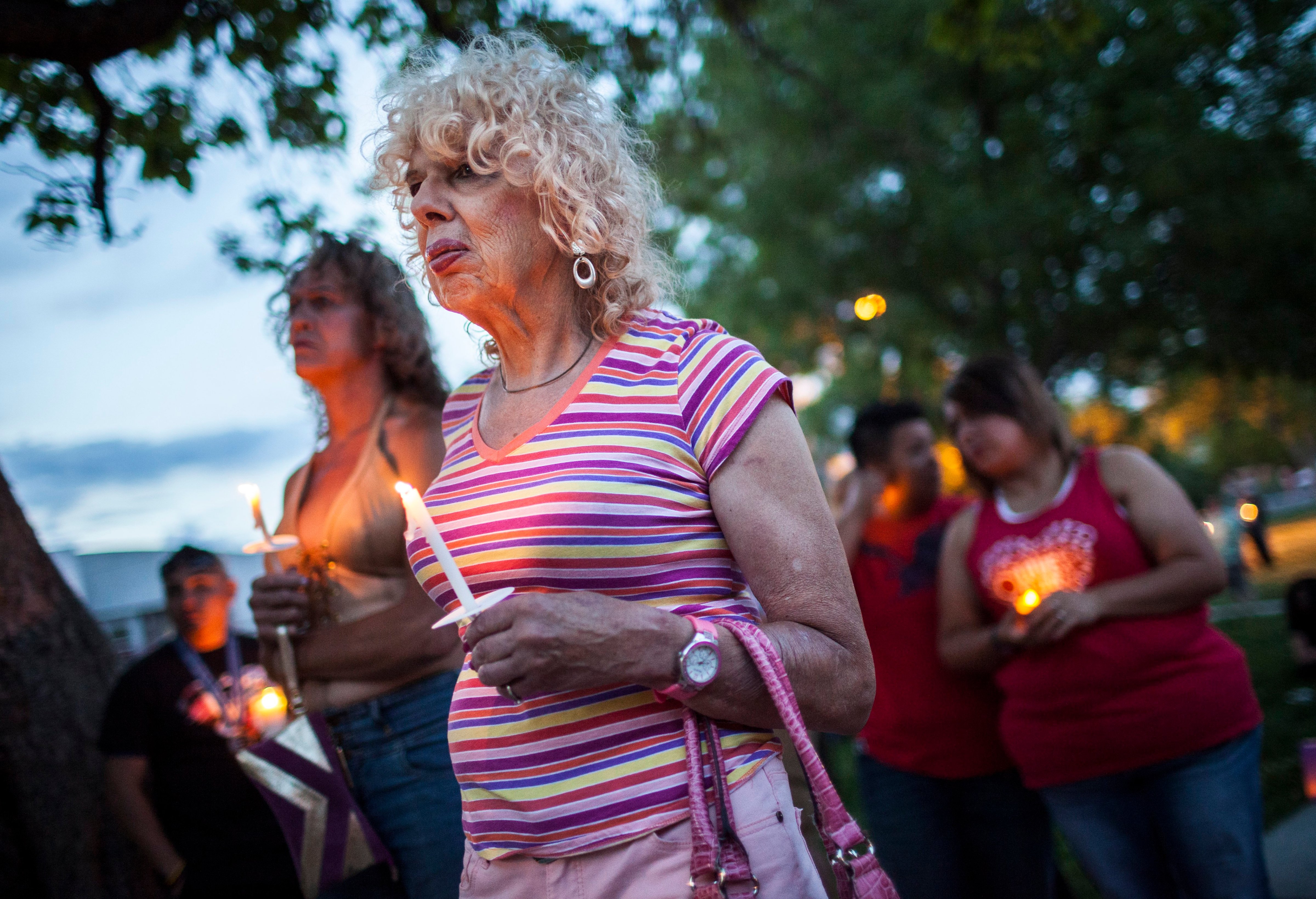 Denee Mallon, center, joins a candlelight vigil organized by Albuquerque Pride in Albuquerque, N.M on May 29, 2014. A U.S. Department of Health and Services review board ruled on May 30, in favor of Mallon, a 74-year-old Army veteran, whose request to have Medicare pay for her genital reconstruction was denied two years ago. (Craig Fritz—AP)