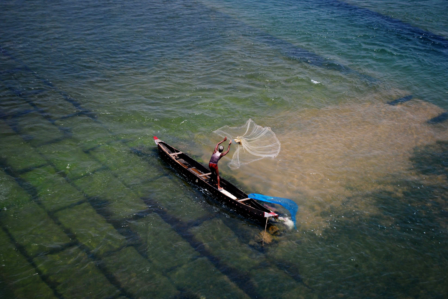 May 1, 2014. A fisherman casts his net into the Mohanadi River near Munduli some 30 kms away from Bhubaneswar, India.