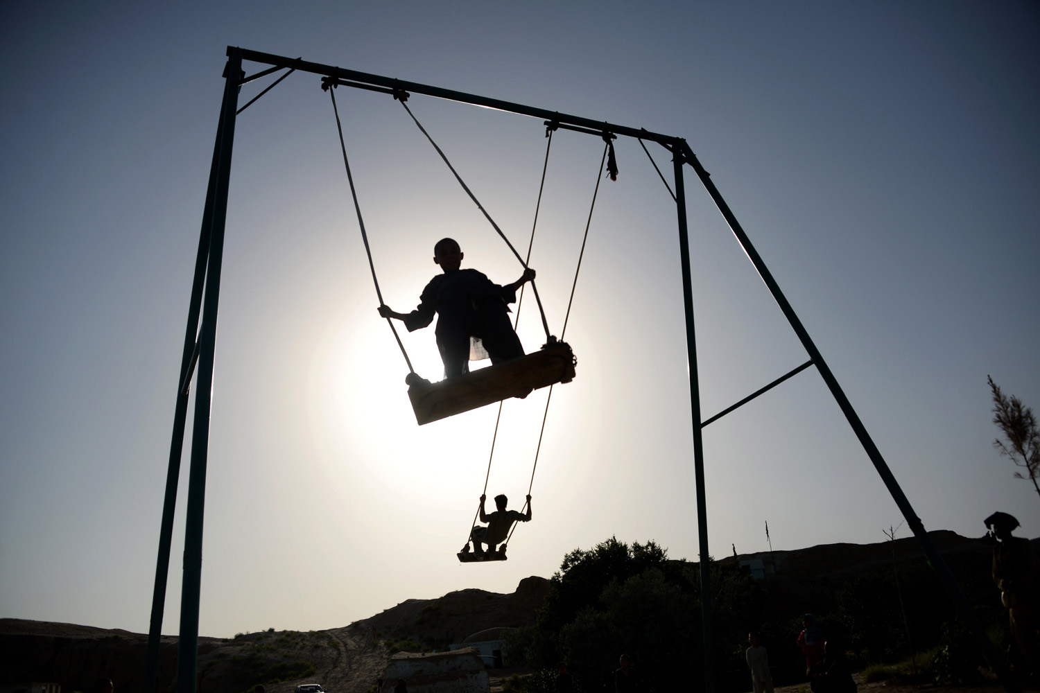 Afghan youth play on swings on the outskirts of Mazar-i-sharif on May 13, 2014.