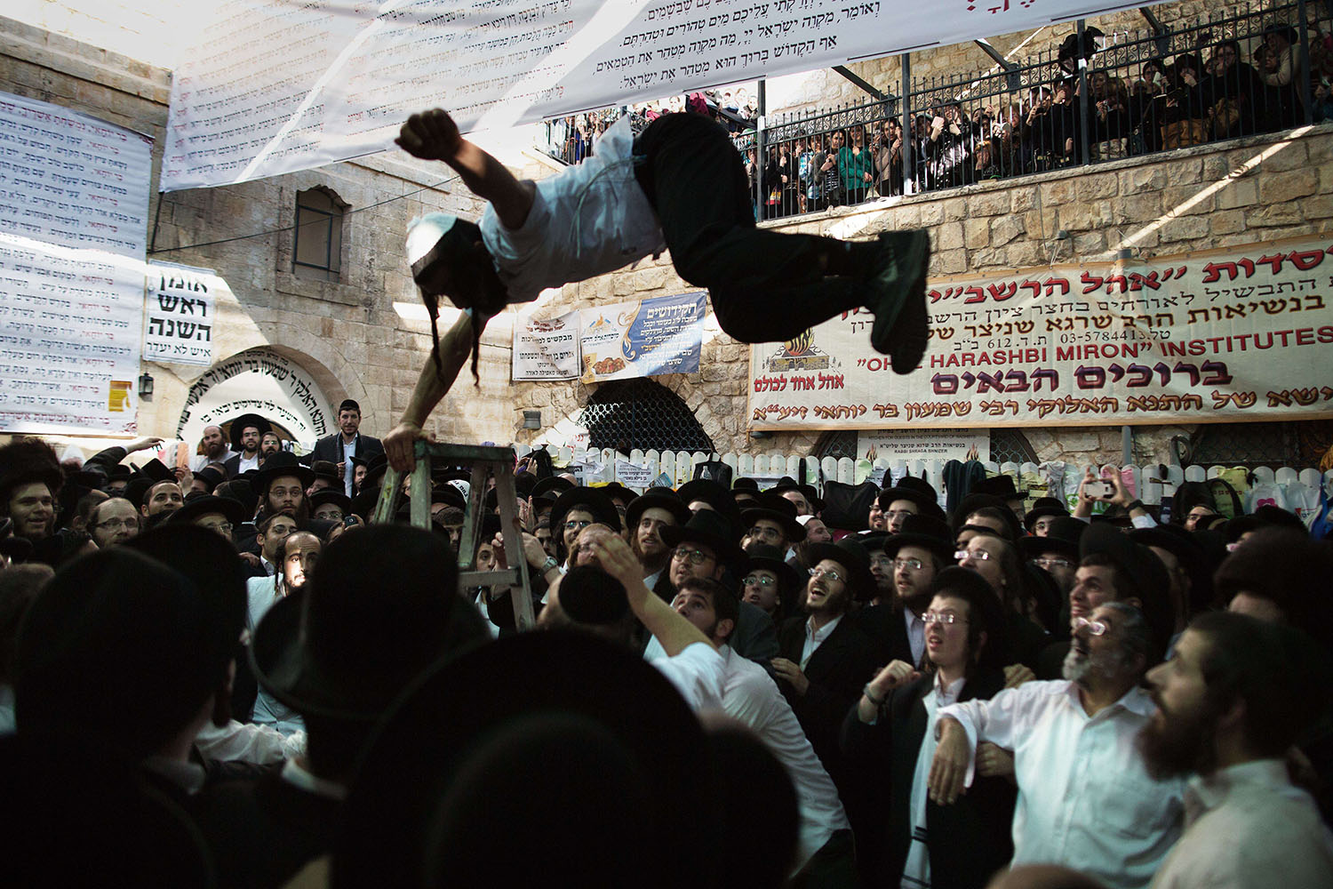 Ultra-Orthodox Jews dance at the grave site of Rabbi Shimon Bar Yochai in the northern Israeli village of Meron on May 18, 2014, at the start of the day-long holiday of Lag Baomer that commemorates the Jewish scholar's death.