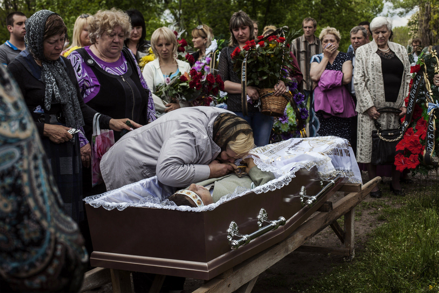 May 13, 2014. Relatives of Hyudych Vadim Yurievichq, including his mother, center, mourn his death, at the Krasnoarmeysk cemetery, eastern Ukraine, May 13, 2014. (Fabio Bucciarelli—AFP/Getty Images)
