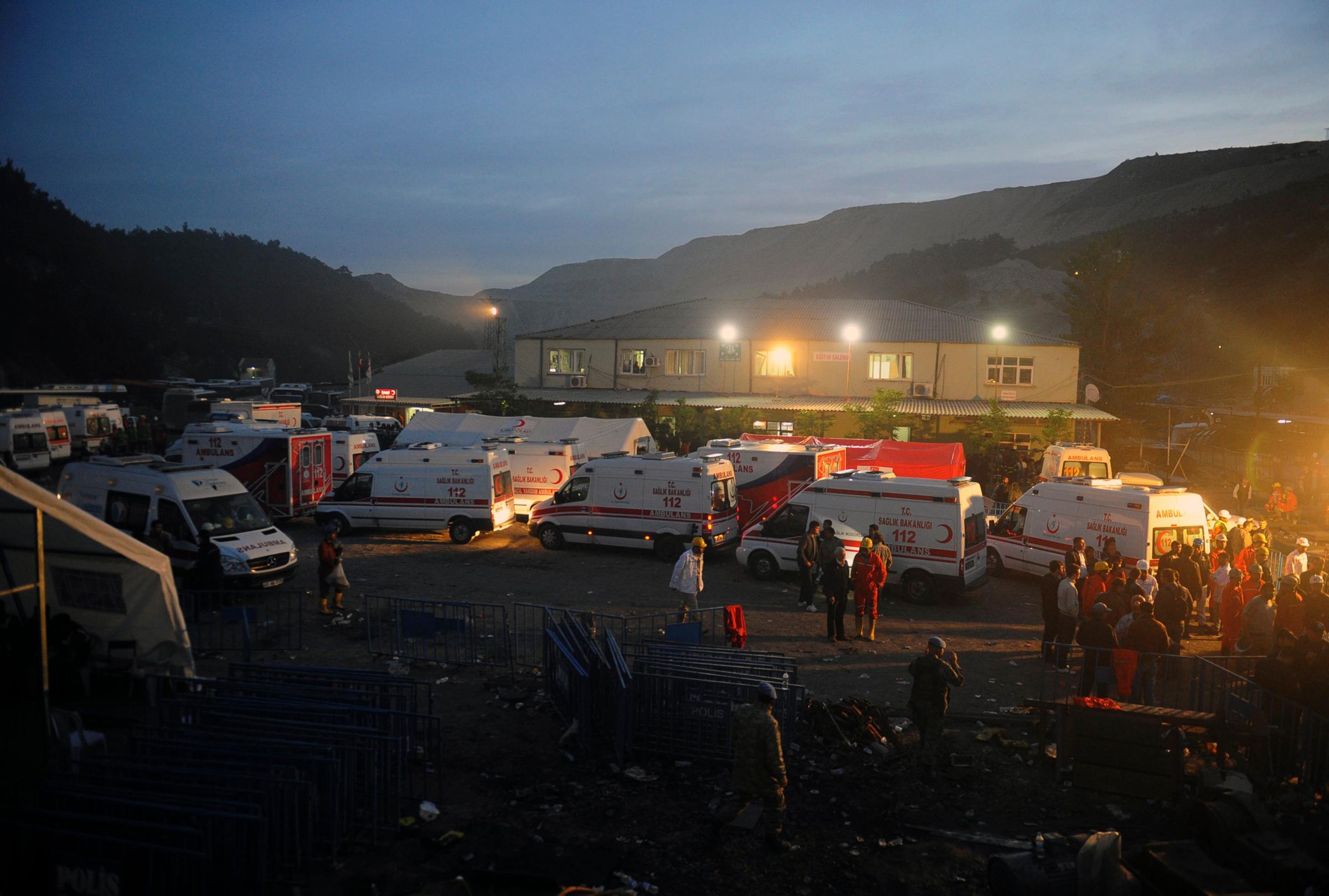 Family members and miners gather around ambulances waiting outside a coal mine in Soma, western Turkey, early Wednesday, May 14, 2014.