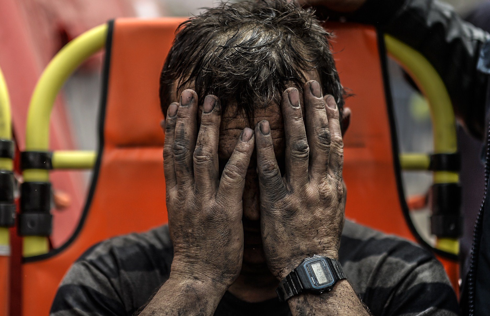 A miner reacts after being affected with toxic gas while searching for co-workers who remain trapped underground on May 14, 2014 after an explosion and fire in their coal mine in the western Turkish province of Manisa.