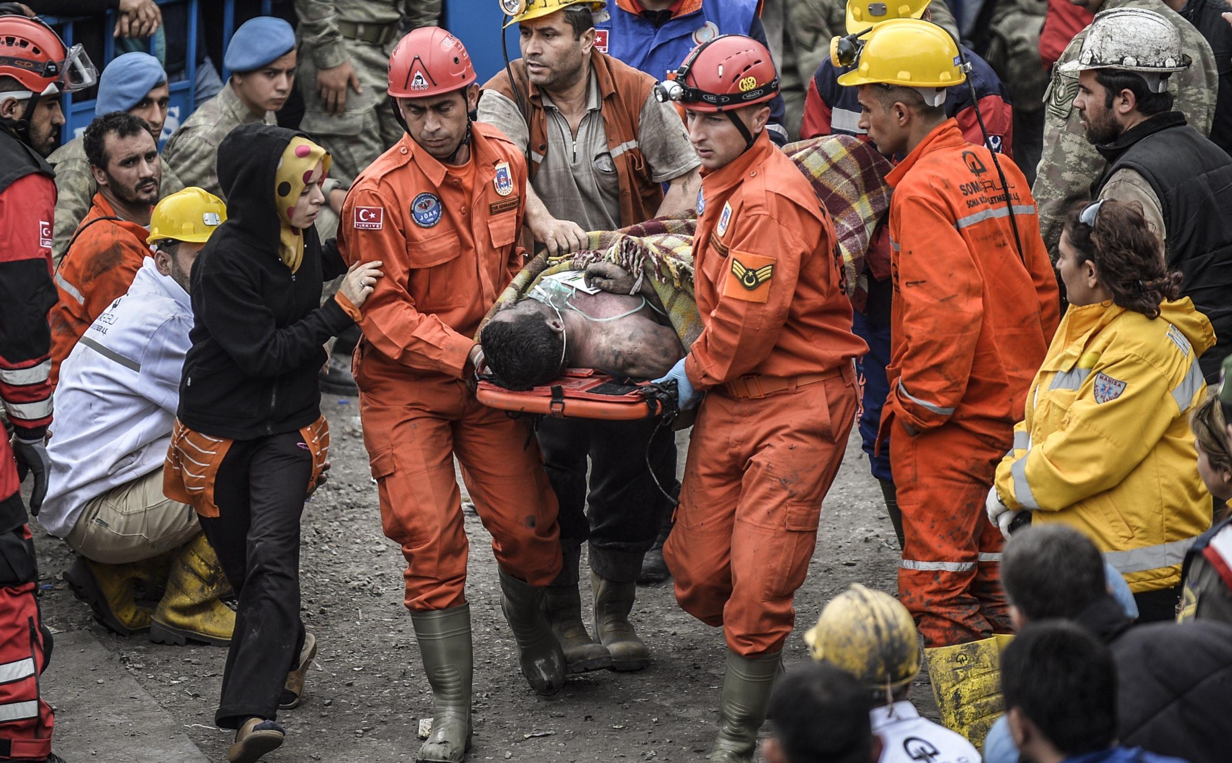 A woman reacts as she searches for relatives while rescuers carry out dead miners on May 14, 2014.