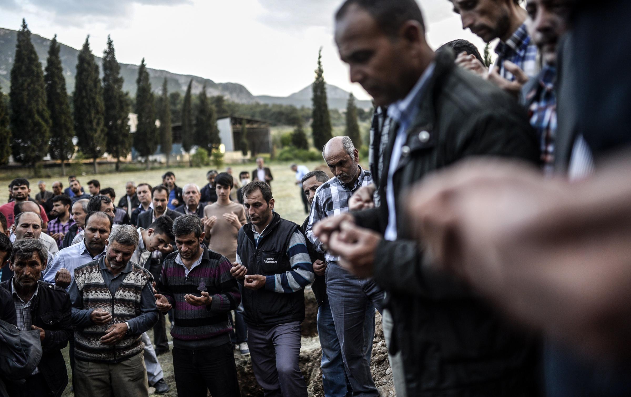 Turkish people mourn in a cemetary in Manisa on May 14, 2014, during the funeral of miners killed in a mine blast the day before in the western Turkish province of Manisa, of which the death toll hit 245.