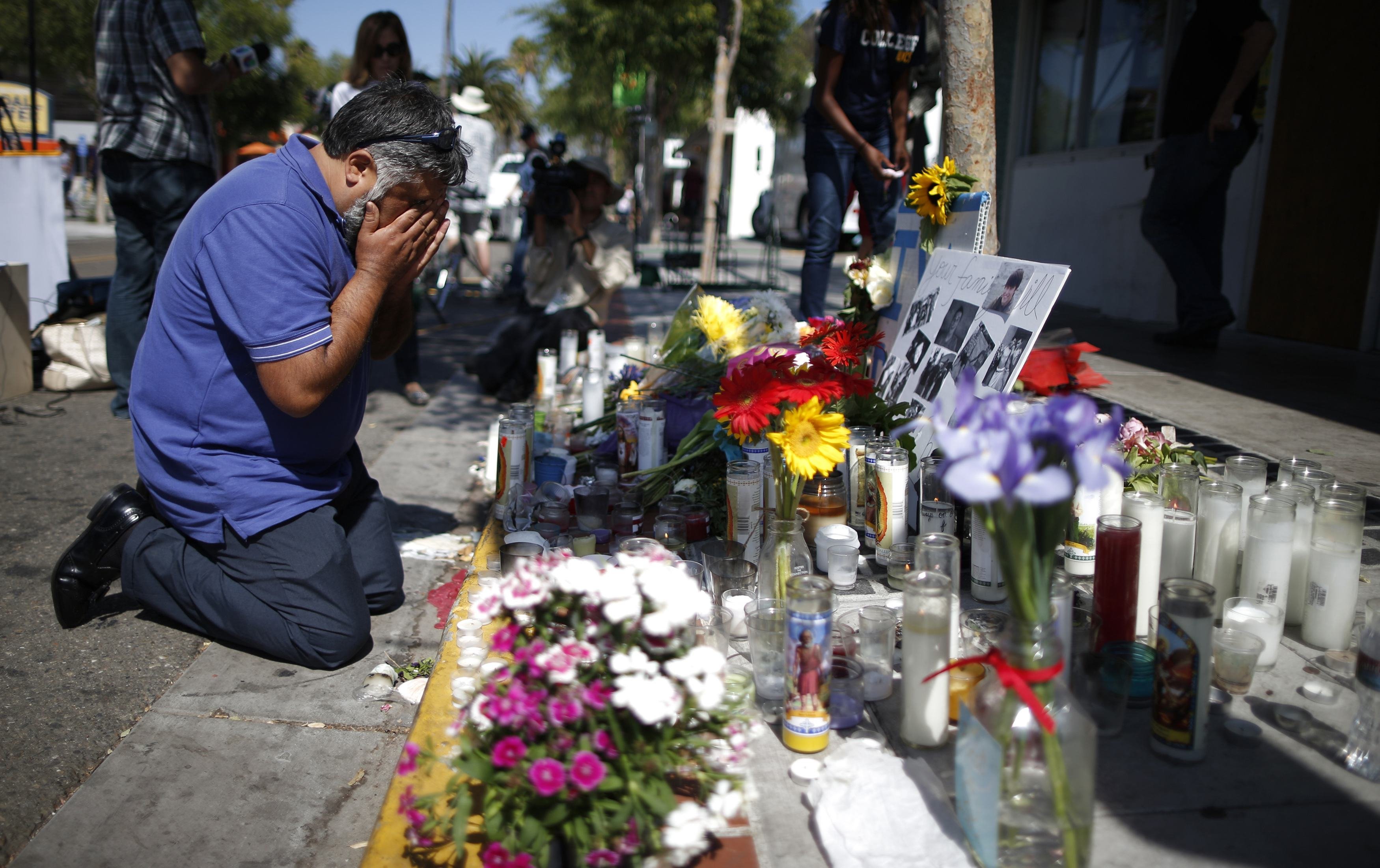 Jose Cardoso, 50, cries in front of a makeshift memorial for 20-year-old UCSB student Christopher Ross Michaels-Martinez outside a deli in Santa Barbara, Calif., on May 25, 2014 (Lucy Nicholson—Reuters)